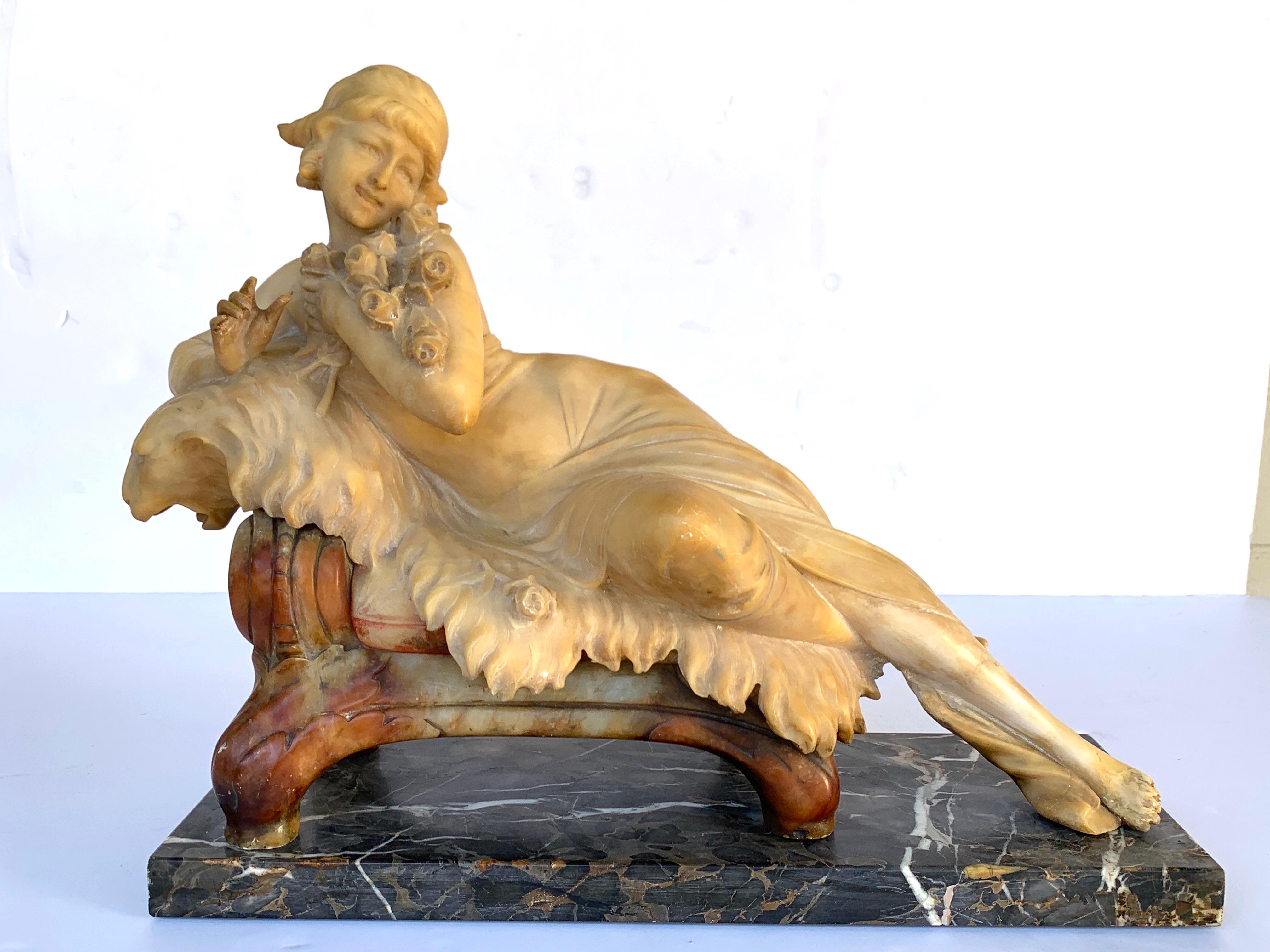 Italian alabaster and marble reclining muse on a lion bench sculpture, in two parts, beautifully carved multi colored stone, artist signature of C Berlincioni, Florence Italy on the base in script
The sculpture measures 20
