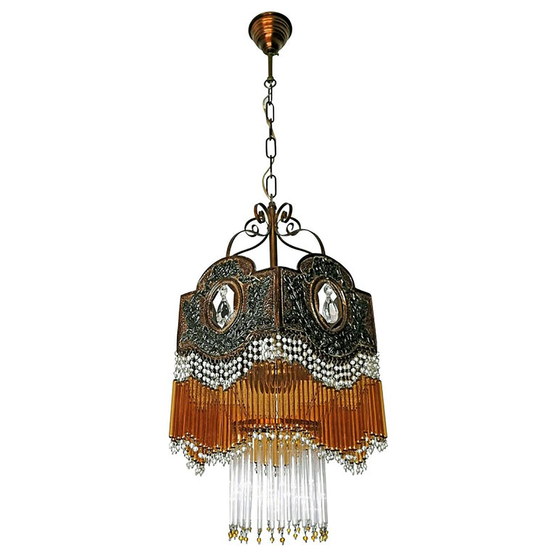 Beautiful Italian midcentury in clear and amber Murano beaded glass Art Deco / Art Nouveau chandelier
Measures:
Diameter 11.8 in/30 cm
Height 35.5 in (chain/11.8 cm)/ 90 cm (chain/30 cm)
One light bulb E27/ good working condition
Assembly