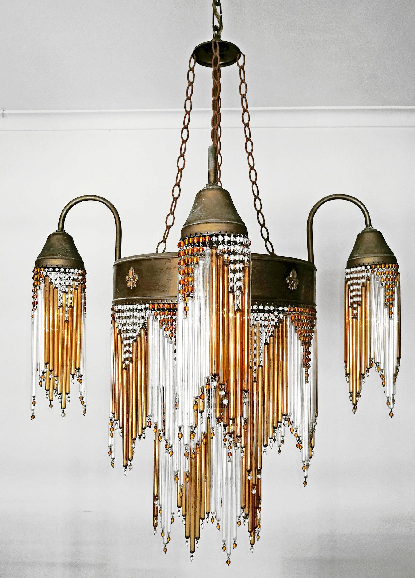 Fabulous midcentury in clear and amber beaded glass Art Deco or Art Nouveau chandelier.
Measures:
Diameter 24.40 in / 62 cm
Height 48.03 in (chain=9.84 in)/ 122 cm (chain=25 cm)
5 light bulbs E14/ good working condition.
Age patina.
Assembly