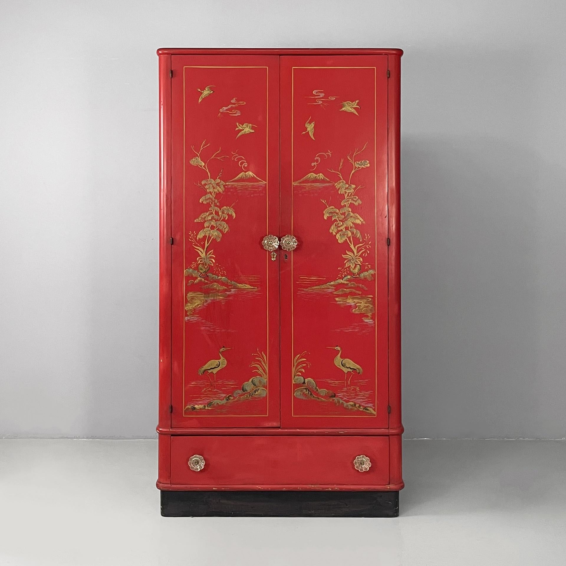 Italian Art Deco Asian-style wooden wardrobe with Murano glass handles, 1930s
Fantastic and vintage wardrobe with double hinged doors and a wooden drawer. The doors are made of red-painted wood with Asian-style gold decorations and light gray