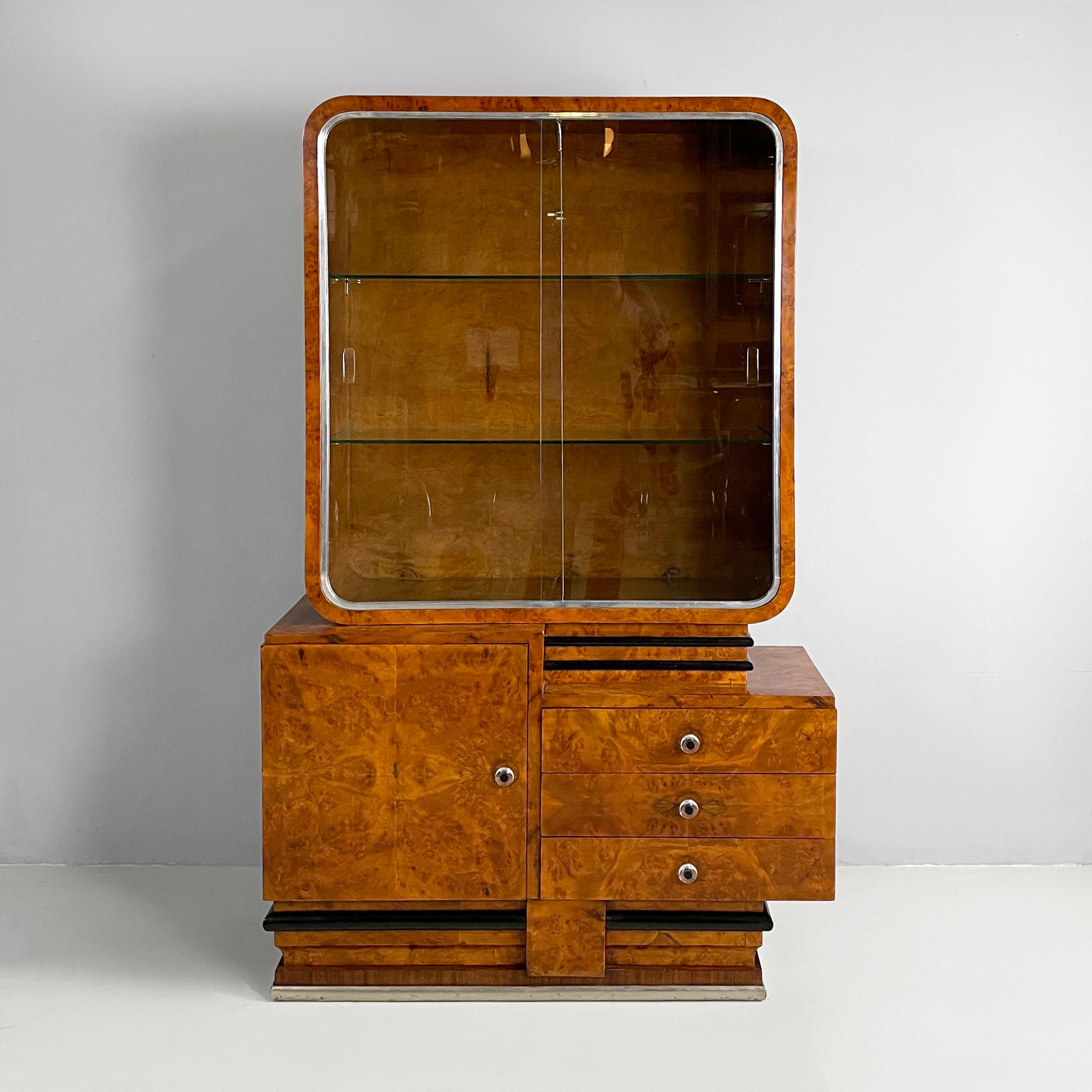 Italian Art Deco asymmetrical wooden sideboard with glass display cabinet, 1920s
Asymmetrical highboard or sideboard with display cabinet in wood and glass. The upper rectangular compartment with rounded corners in wood has two glass sliding doors