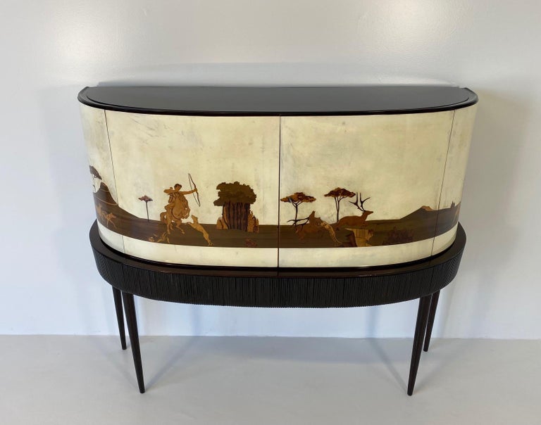 This bar cabinet was produced in Italy, in the late 1930s and is a really unique and special piece.
Its tremendous historical and artistic value is what makes this item a real piece of art, hard to find and one of a kind. 

Firstly, let's talk