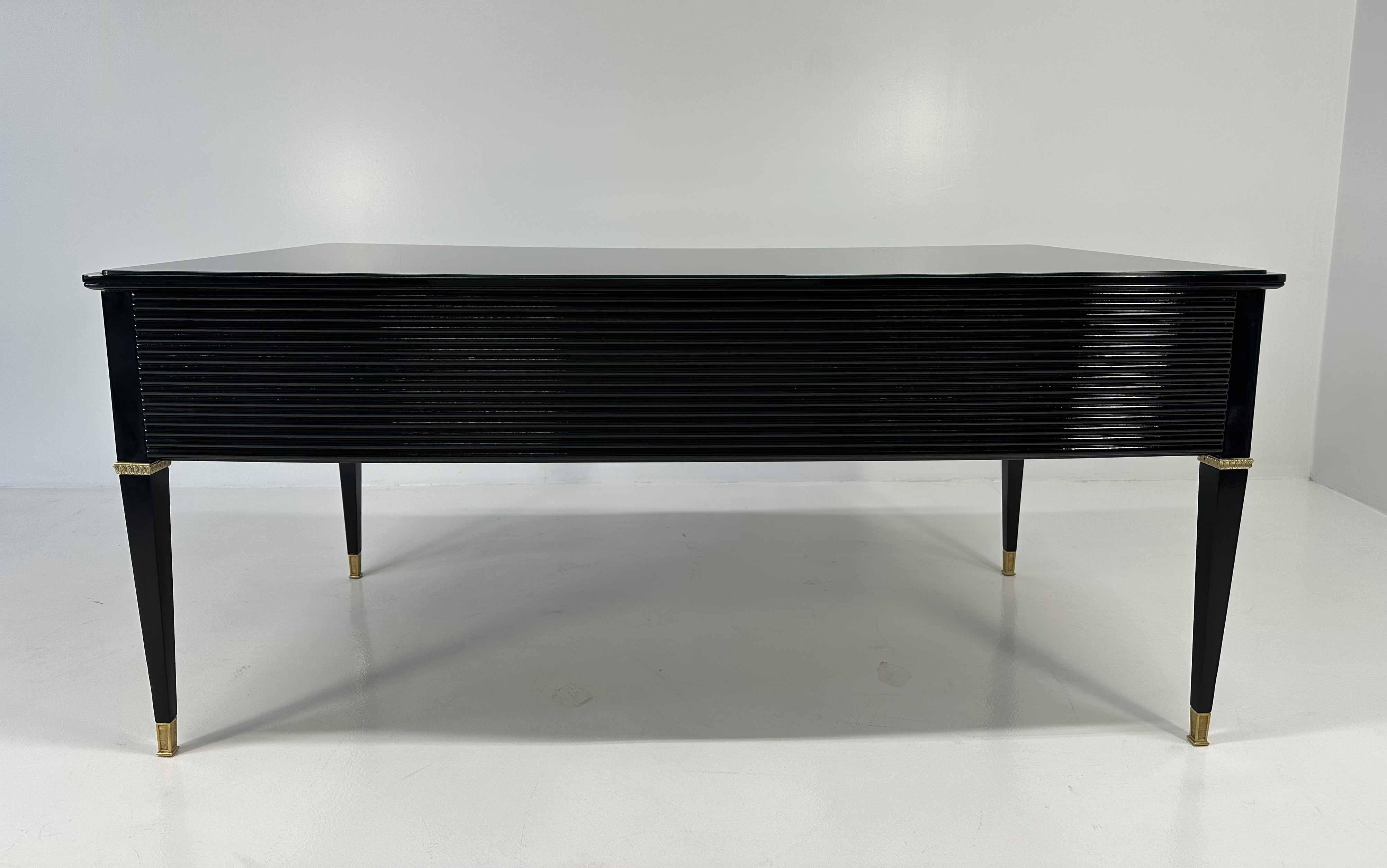 This Art Deco desk was produced in Italy in the 1950s and it was designed by Paolo Buffa for the 'Permanente Mobili Cantù', which used to be one of the most famous and finest furniture exposition of the Art Deco era. 
There is a stamp inside one of