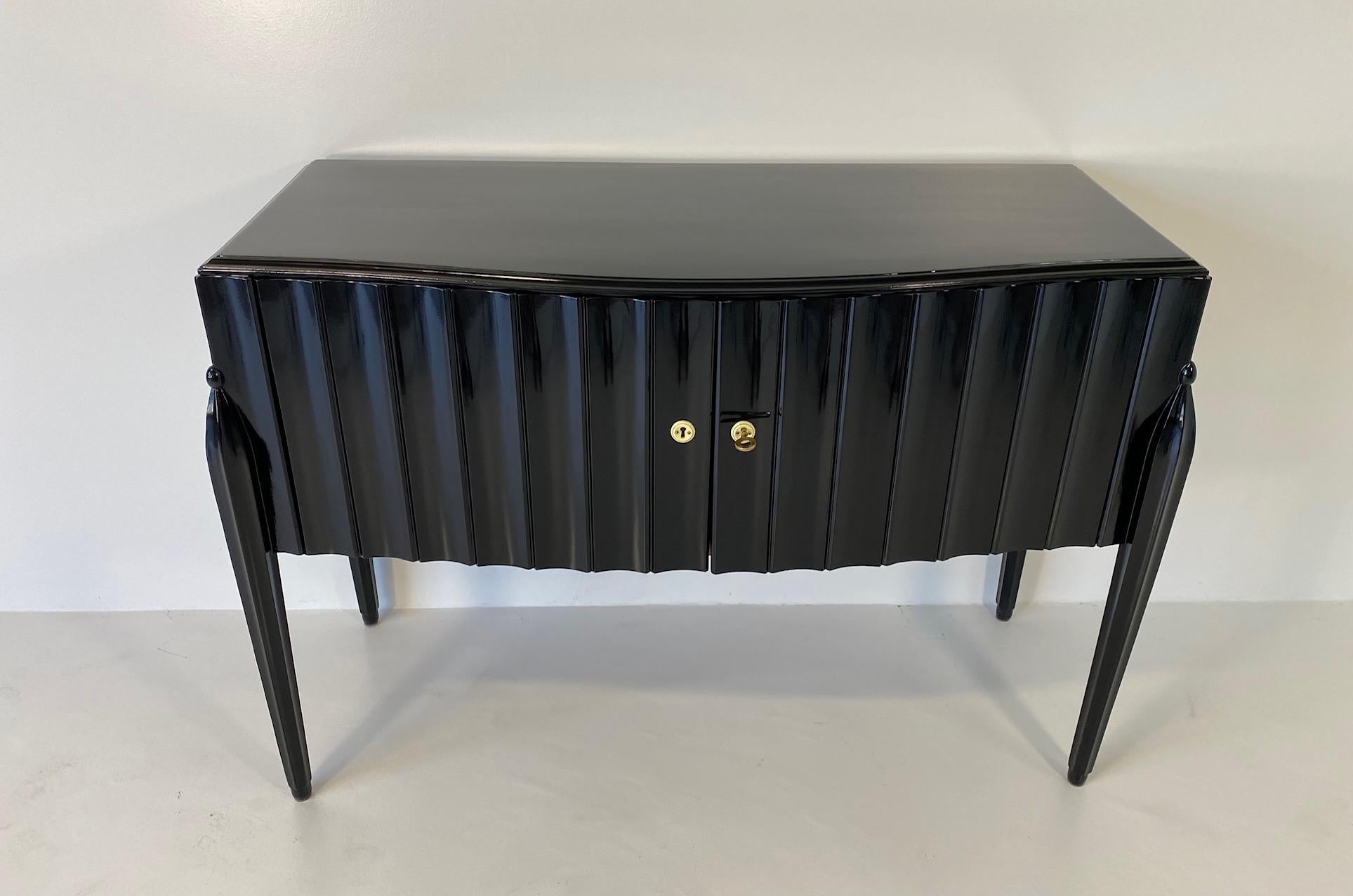 This Art Deco sideboard was produced in Italy in the late 1940s. 
It is completely black lacquered and clearly reminds a design by Guglielmo Ulrich. 

Completely restored.