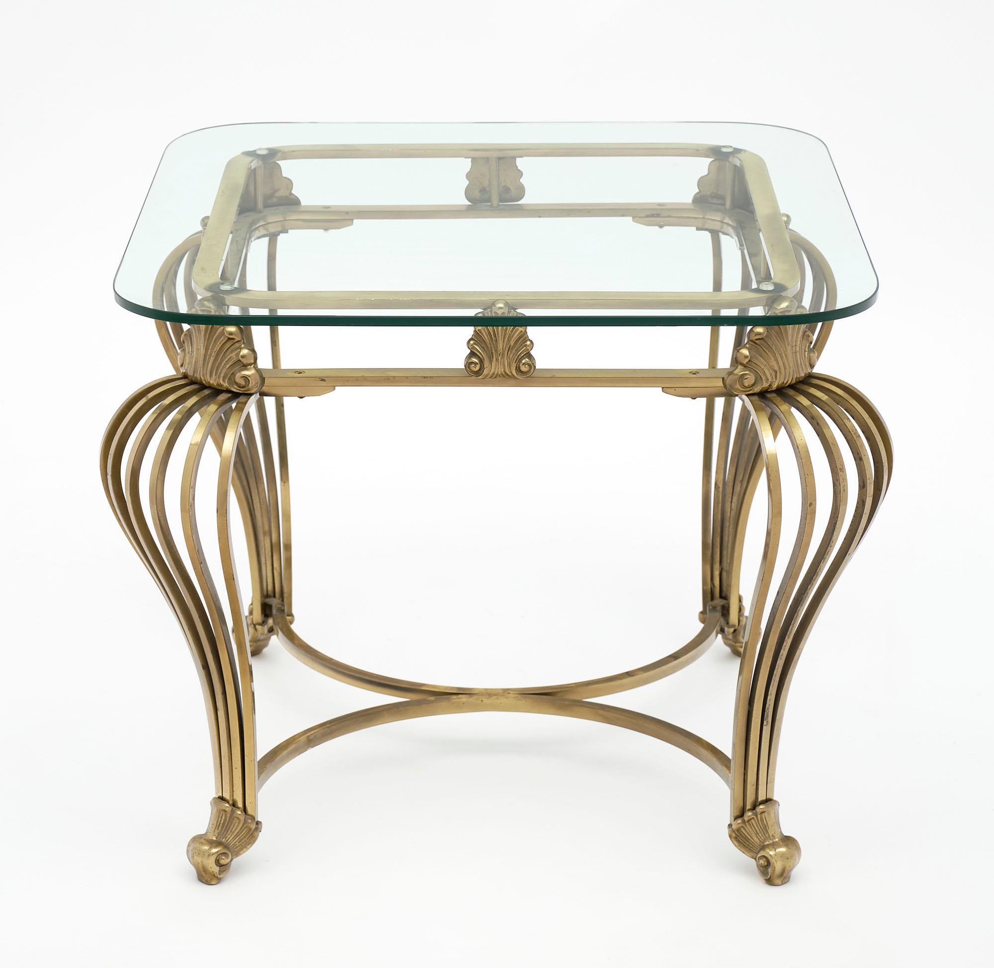 Side table of solid brass form the Italian Art Deco Period. This exceptional piece boasts stylized cabriole legs and shells are featuring in the apron.