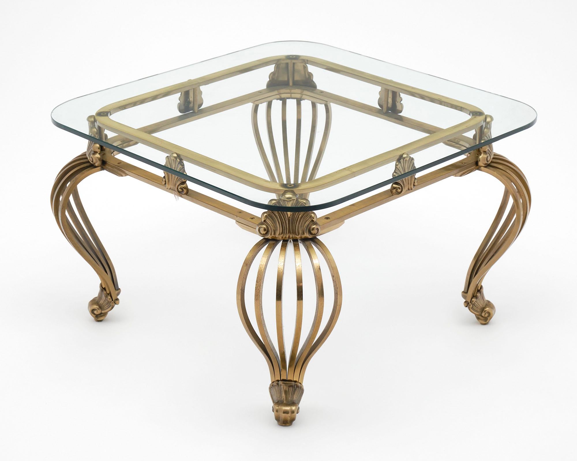 Side table of solid brass form the Italian Art Deco Period. This exceptional piece boasts stylized cabriole legs and shells are featuring in the apron.