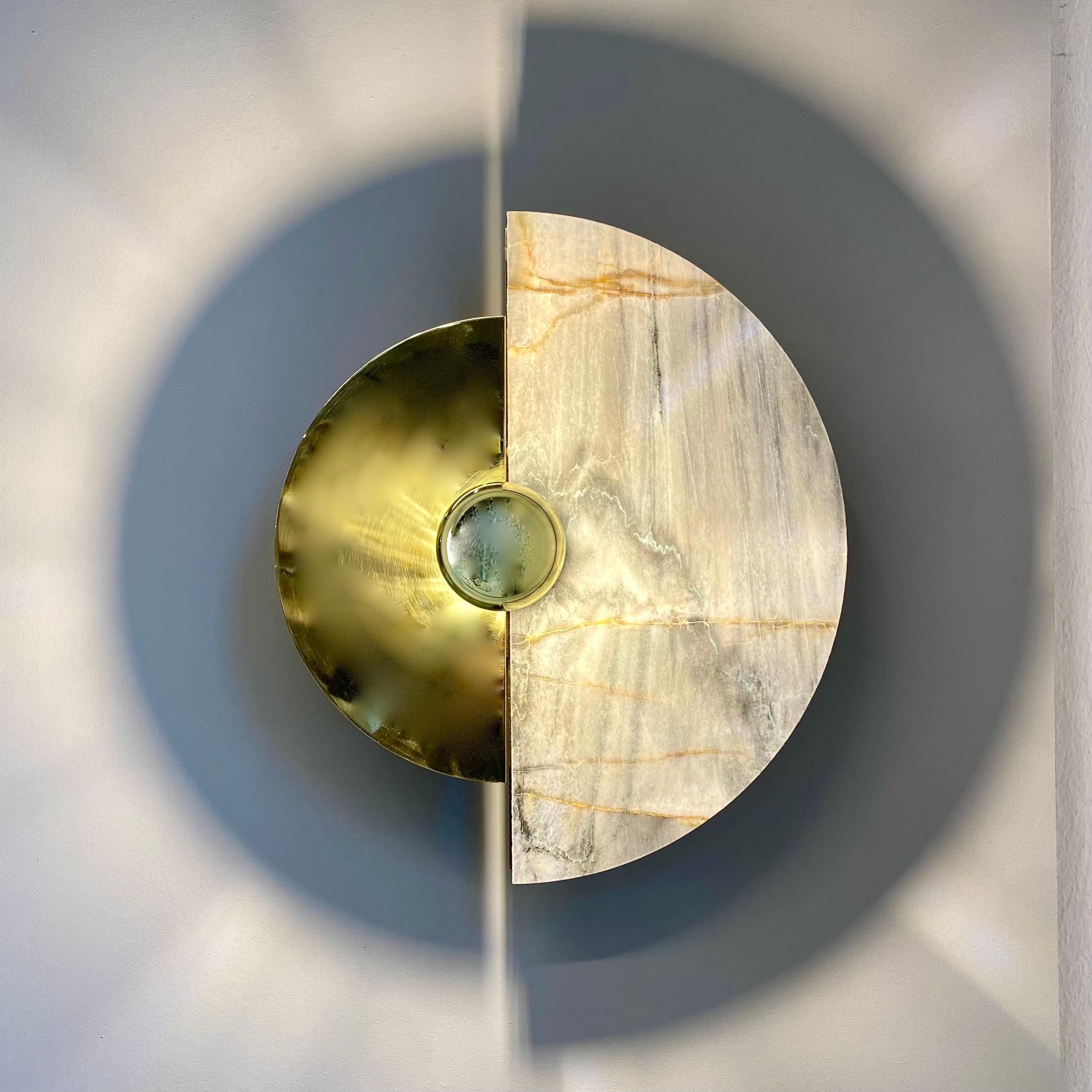 The Levante wall sconce with its circular shape is a strong reference to the sun. 
This design element gives the sconce an artistic and symbolic quality that can add interest and meaning to the decor of a room. The circular shape is often