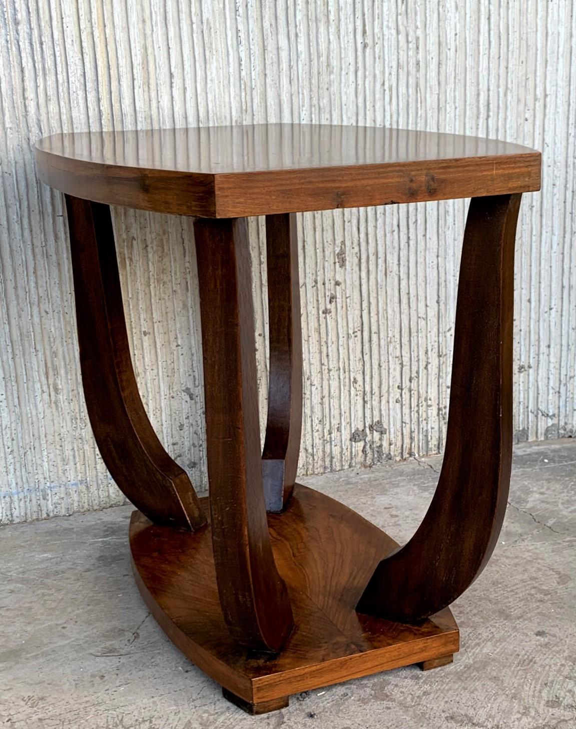 Italian Art Deco rectangular, oval side table, circa 1930s. Narrow ebonized feet and round finial at center base set off the figured walnut. Lower smaller round tier. Unknown maker.