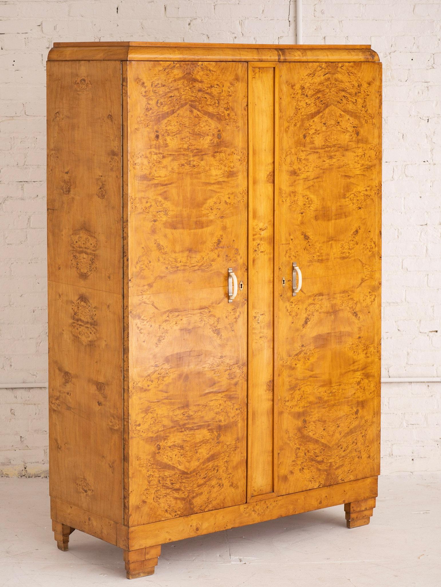 1930s Art Deco burl wood wardrobe. Sourced in Italy. Wardrobe features two lower inner shelves and upper clothes bar. Celluloid handles. Key not included.