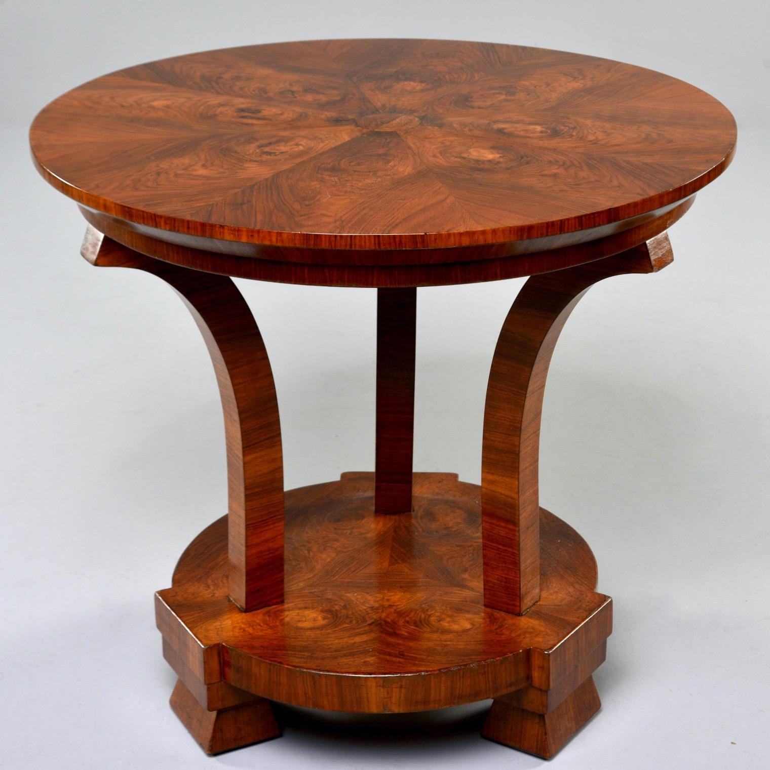 Italian center table with burled walnut veneer in bookmarked grain patterns, circa 1930s. Unknown maker. Very good vintage condition with scattered surface wear.