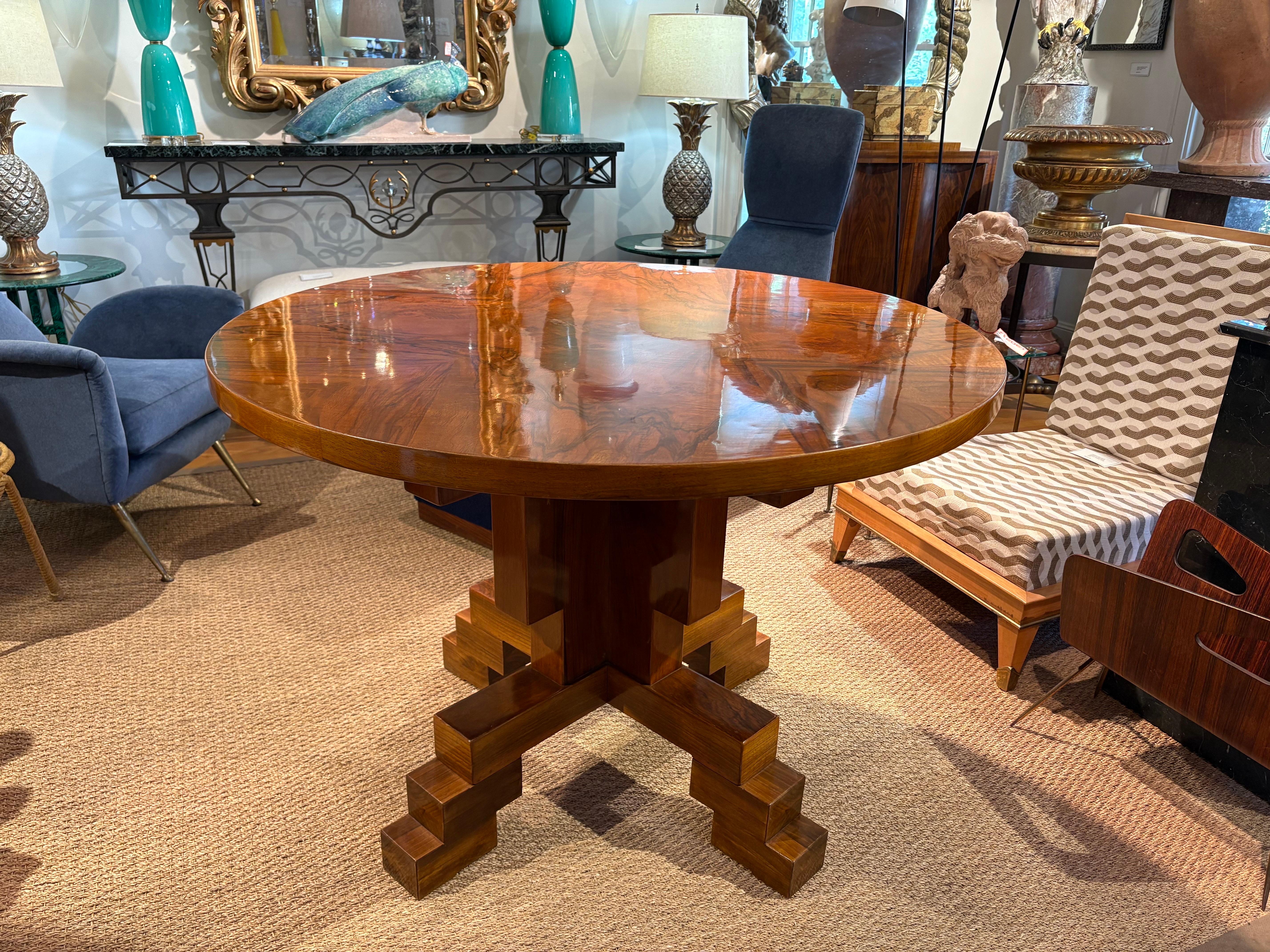 Italian Art Deco Center Table. 
Offered is a handsome period Italian Art Deco center table, dining table or game table
with an interesting geometric skyscraper base and beautiful burled top.
This versatile table will work well in a variety of