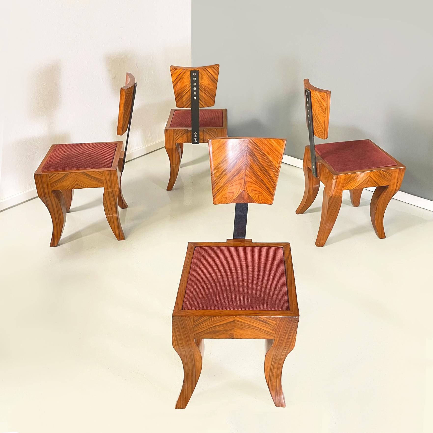 Italian Art Deco chairs in solid wood, black metal and red fabric, 1920-1930s
Set of 10 Art Deco dining chairs with polished solid wood structure. The seat is composed of a lightly padded square cushion covered in red fabric, inserted into the