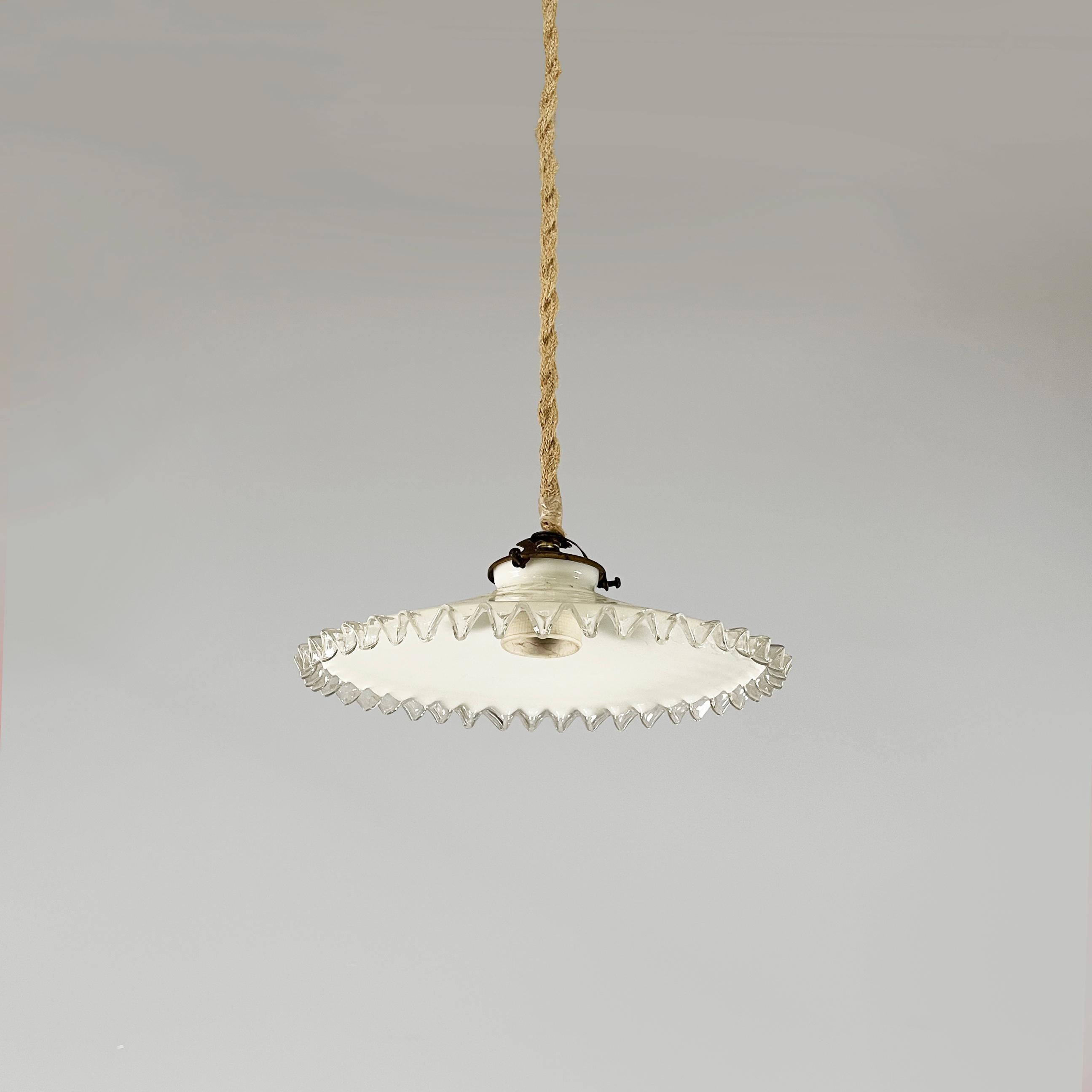 Italian art deco chandelier in white and transparent glass, early 1900s
Fantastic chandelier with conical lampshade in white glass with wavy profile in transparent glass. Burnished brass chandelier attachment. 
Early 1900s.
Good condition. Signs of