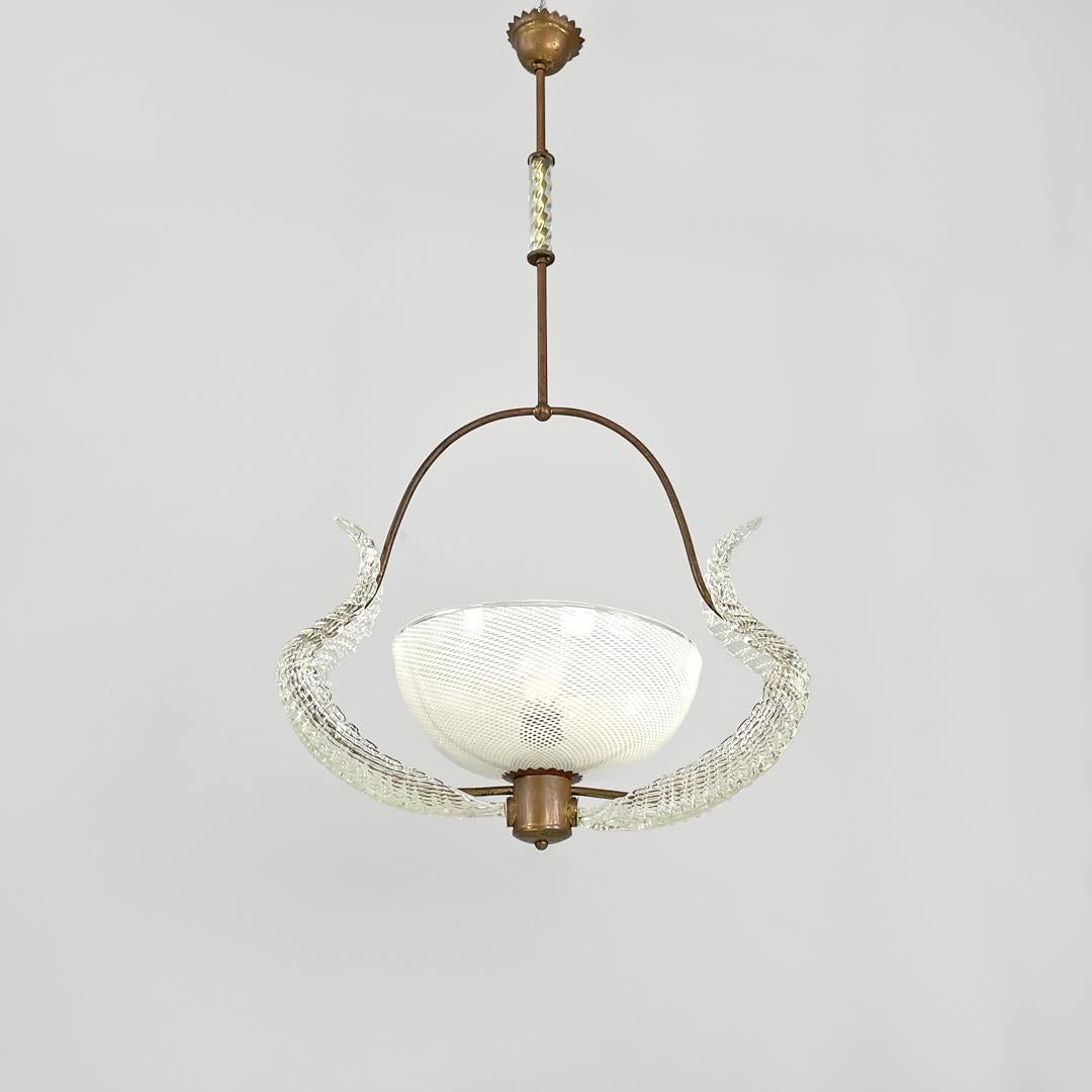 Italian Art Deco chandelier transparent and white Murano glass and brass, 1940s
Murano glass chandelier. The structure is made of brass rod, it extends from the rosette and presents a decorative cylinder in transparent glass, to then create a