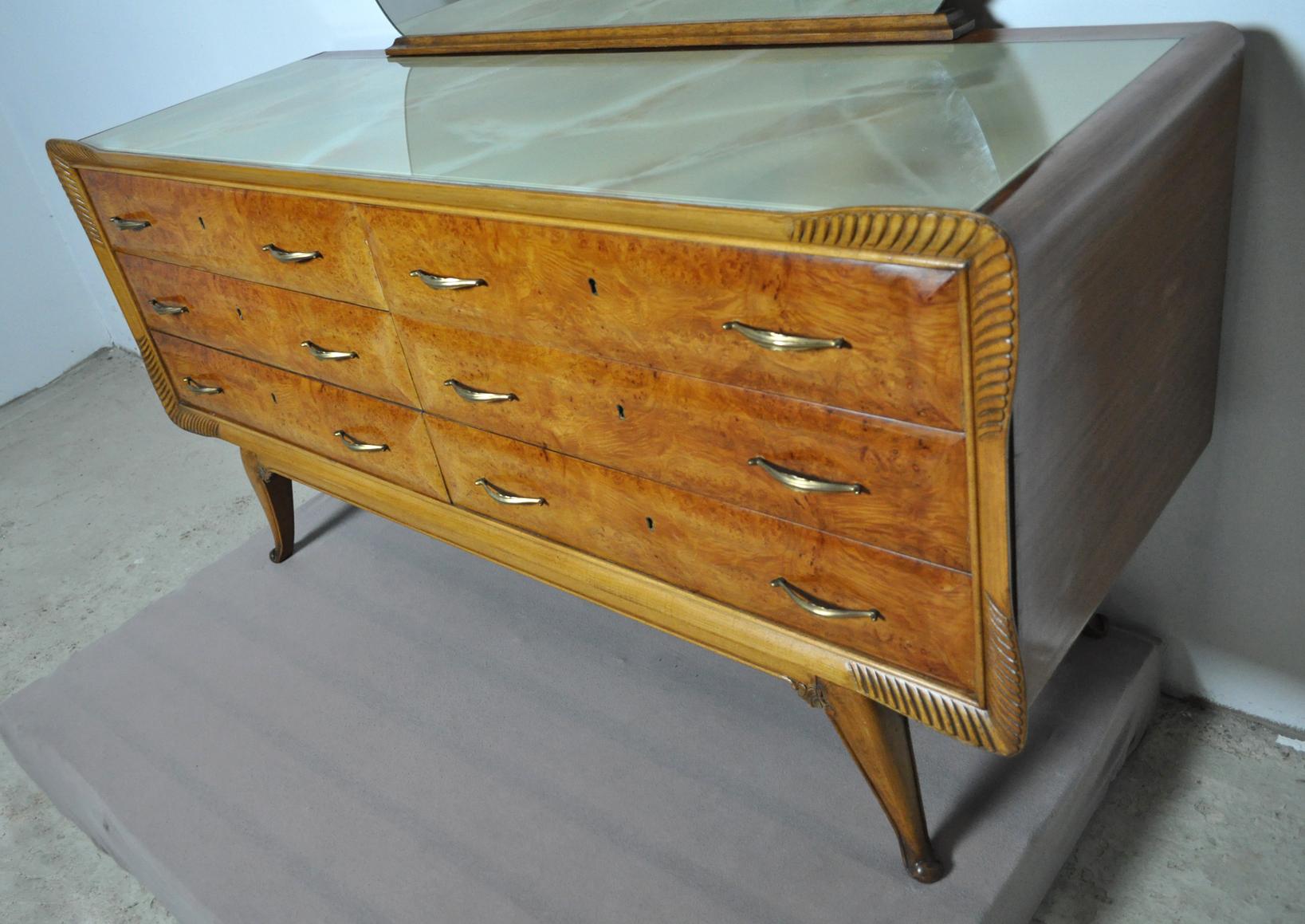 Italian Art Deco walnut and bird's-eye maple commode with mirror.
Six curved drawers with brass handles and a marbled glass top.
Fine carved details on legs and front.

Very good condition with a few related marks. No scratches on