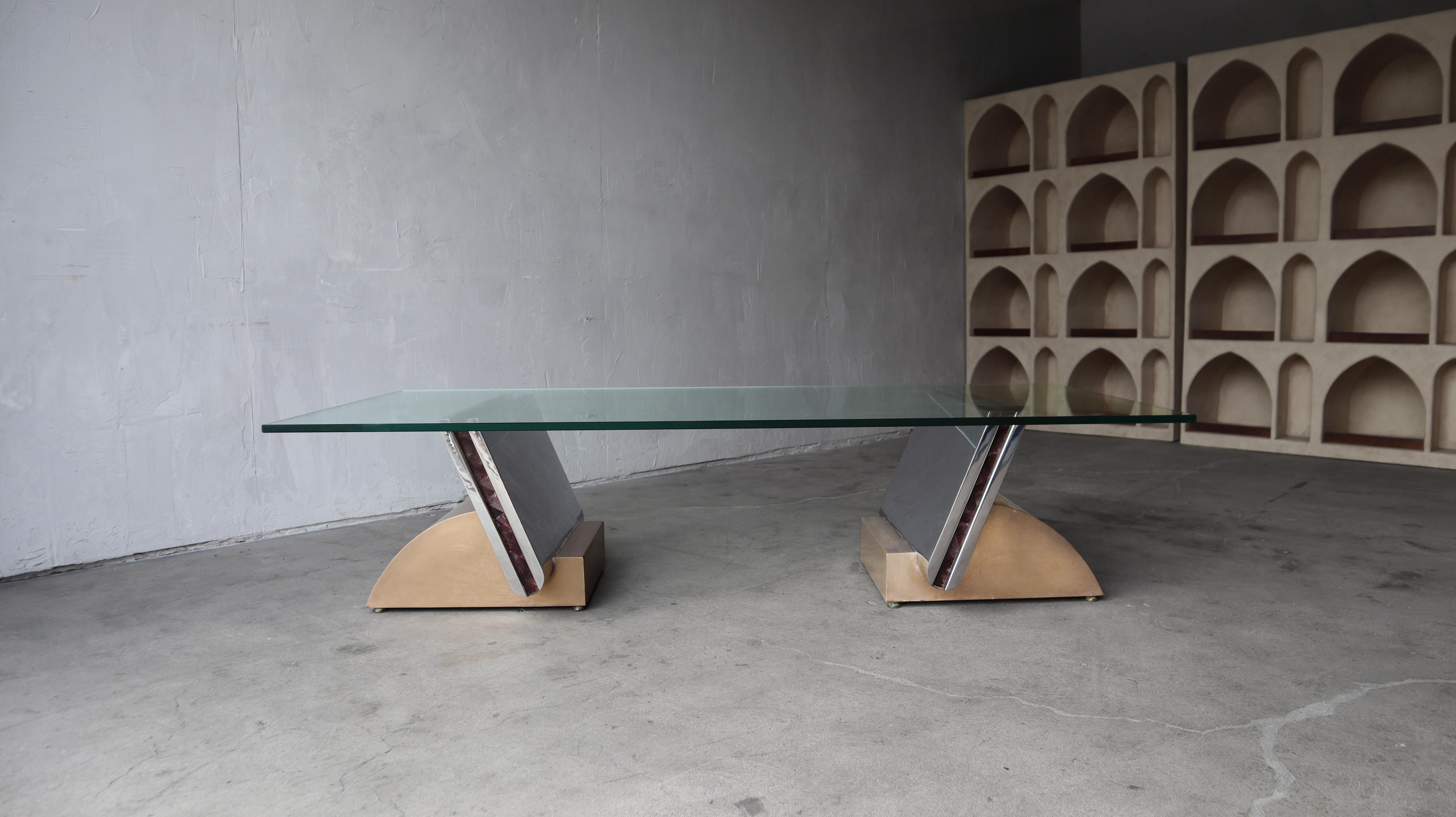 This Rare Italian Art Deco Bookend Style Pedestal coffee table is INCREDIBLE. The 2 bases are constructed out of polished stainless, bronze with a gemstone inlay (appears to be Almandine Garnet).  These table bases are stunning, unique pieces, true