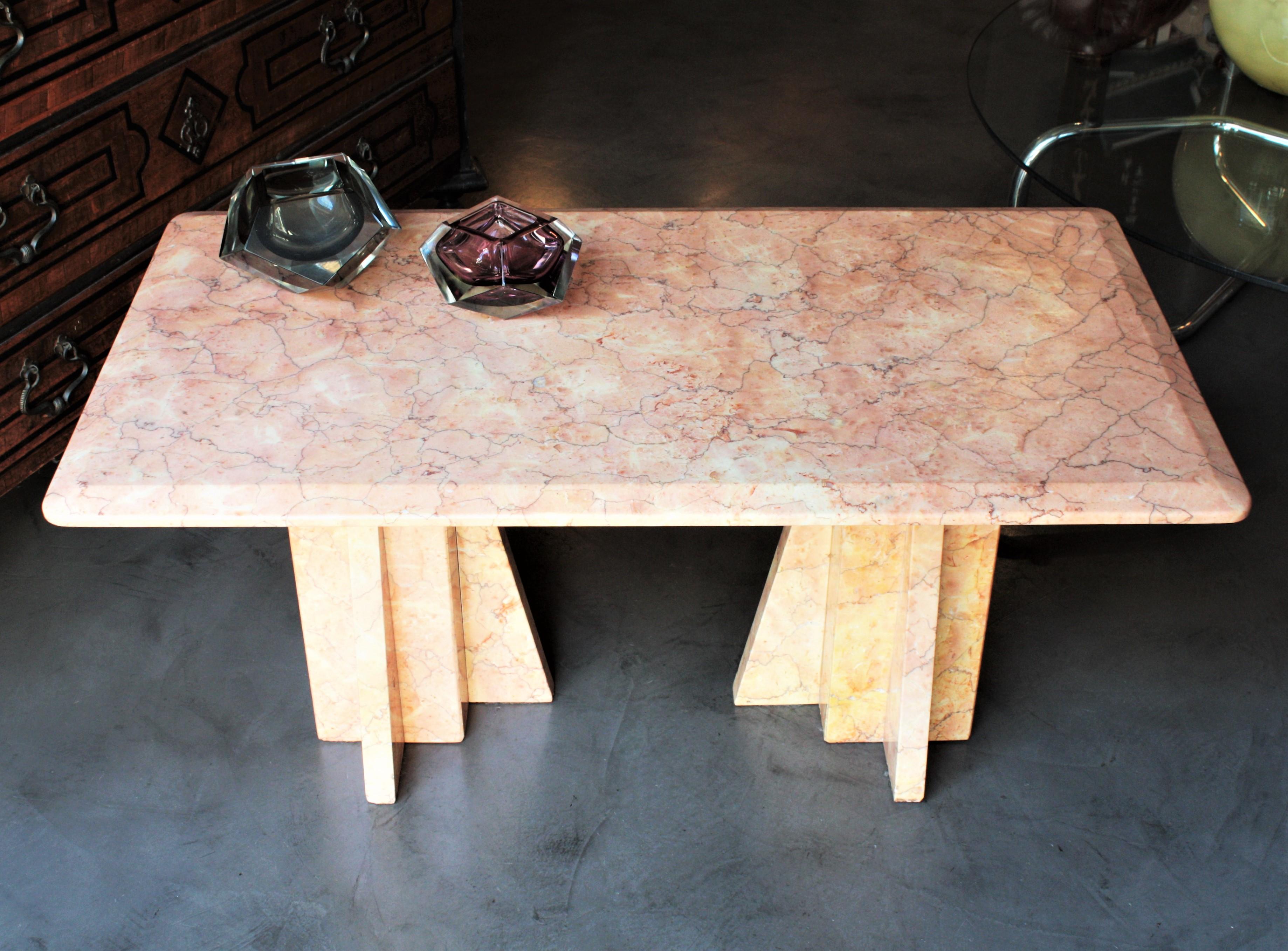 Outstanding Art Deco pink marble low table consisting in a rectangular top with two geometric bases, Italy, 1930s.
This gorgeous table is all made in marble. The top rest on two monolithic geometric bases.
All the marble surfaces has rose, pink,