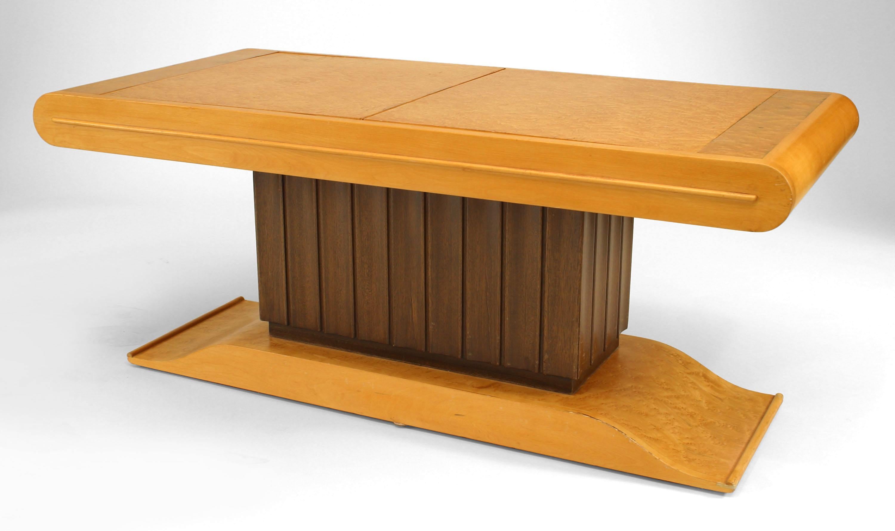 Italian Art Deco (1930s) rectangular birdseye maple coffee table with two top doors that open up to a central fluted pedestal section with a dark stained finish that contains a bar cabinet.
