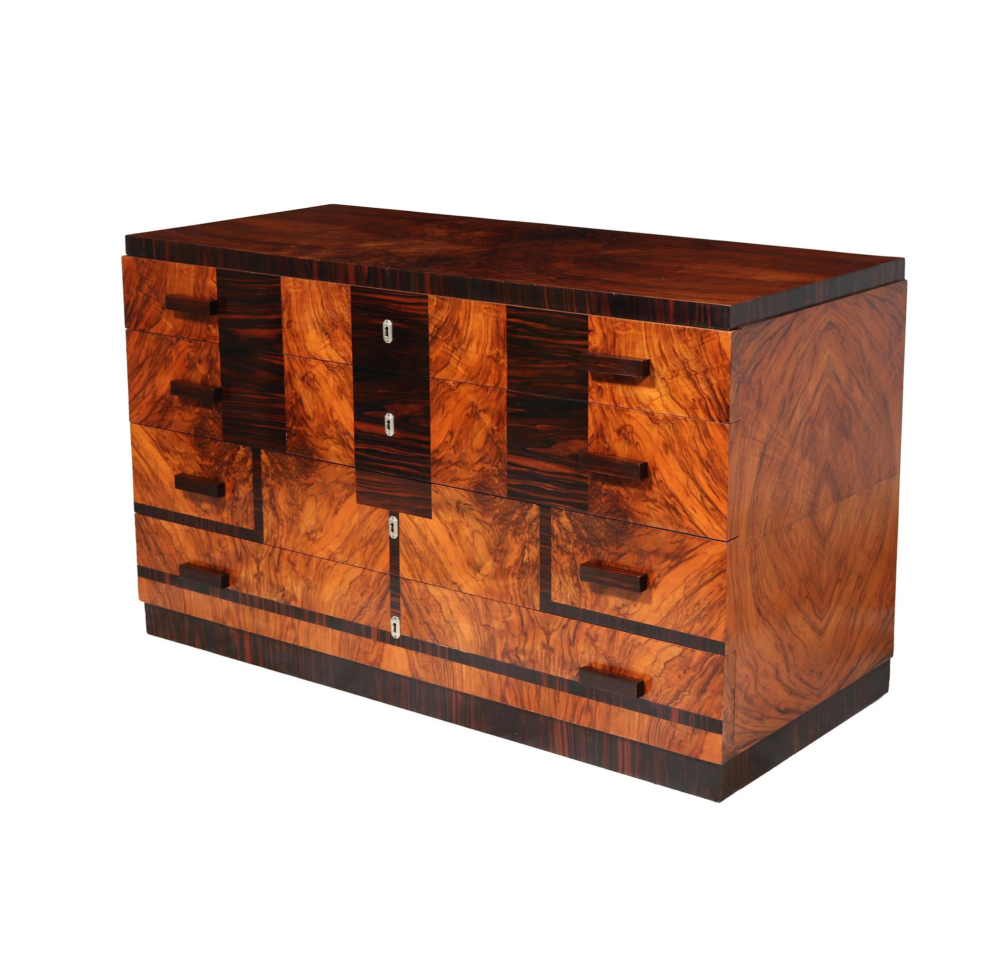 ITALIAN ART DECO COMMODE
This exceptional Art Deco Commode from 1930s Italy, boasting a very stylish design that combines walnut with intricate Macassar ebony inlay detailing. Its four spacious drawers are adorned with elegant chrome escutcheons and