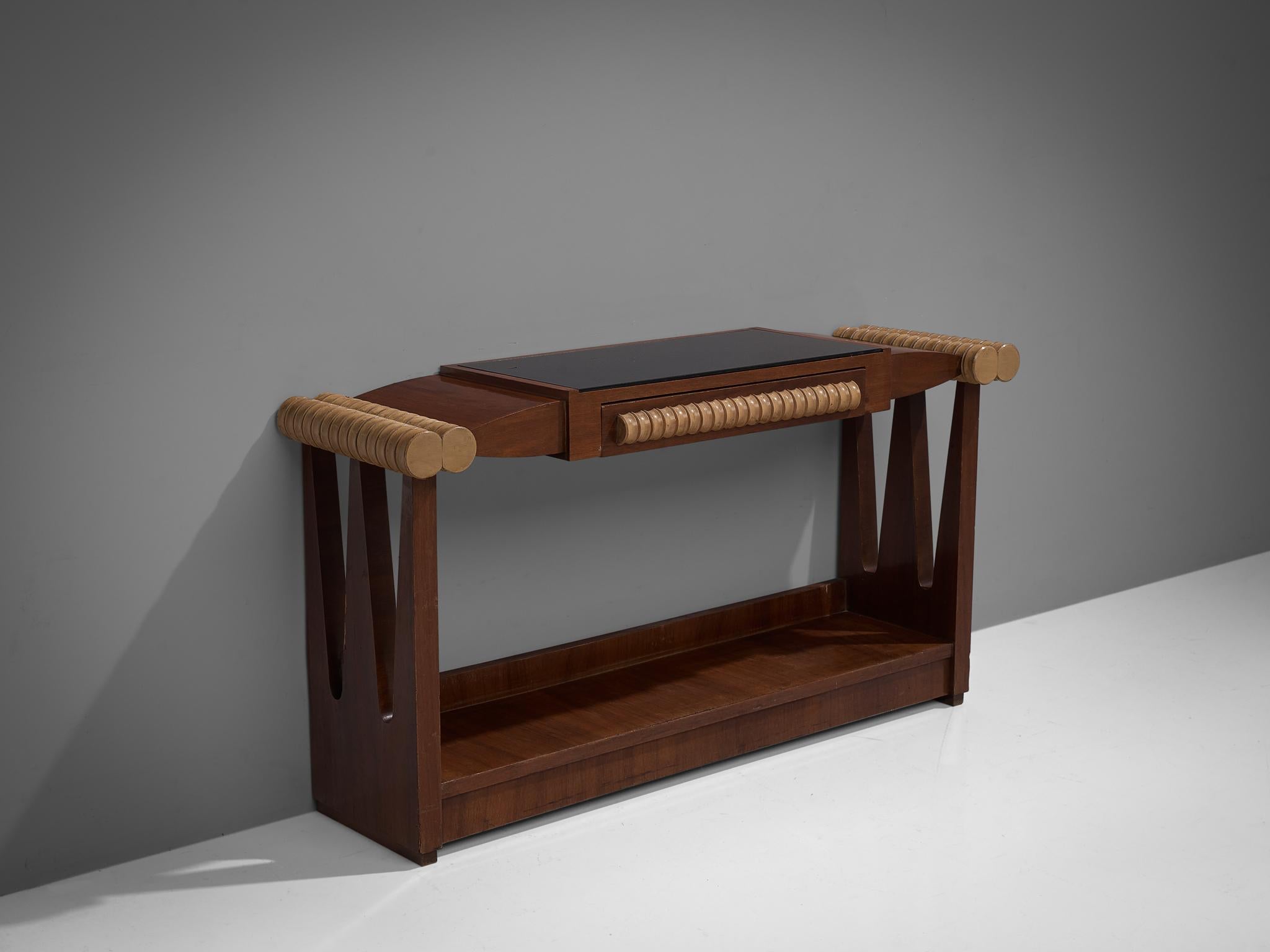 Console, maple, walnut and glass, Italy, 1940s

This Italian console has been manufactured in walnut, with contrasting sculptural elements in maple. These highly decorative elements in maple function as a handle for the shallow drawer in the