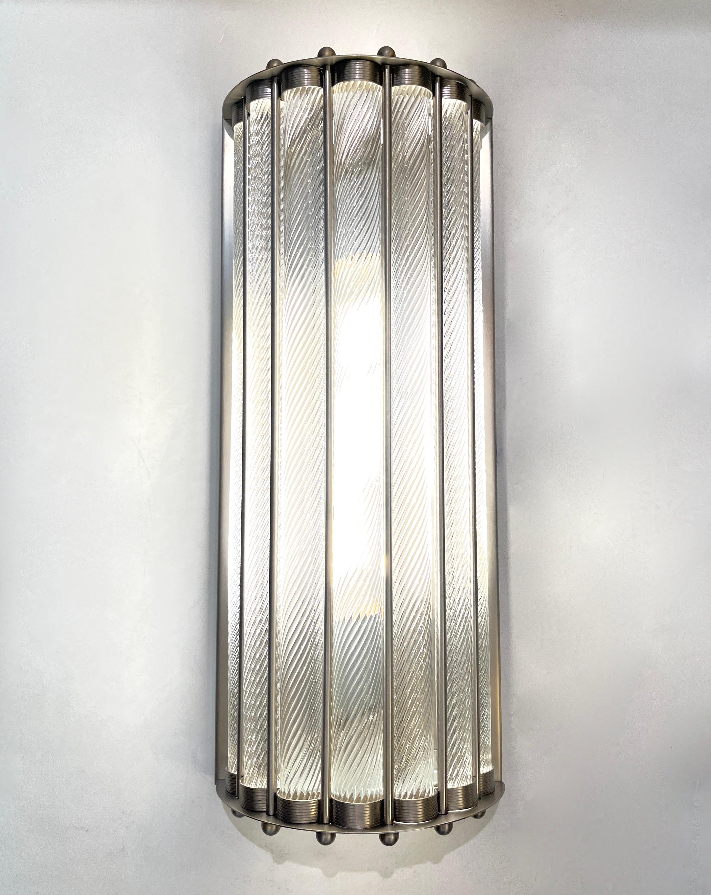 Contemporary customizable Italian Art Deco Design pair of semi-circular wall lights, entirely handcrafted, with a satin nickel finish, exclusive design by Cosulich Interiors & Antiques. The nicely scalloped airy structure supports crystal clear