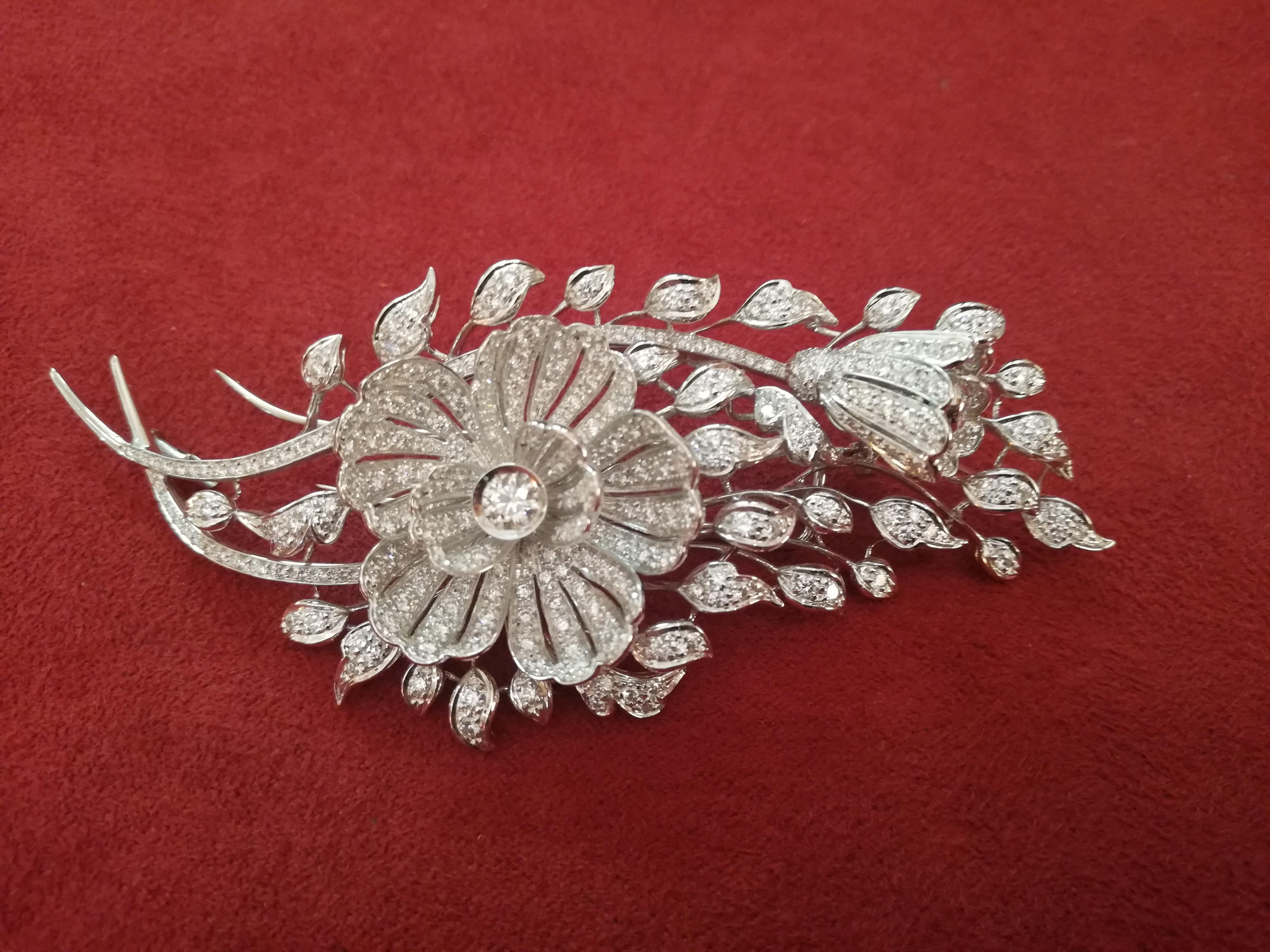 A beautiful Art Deco flower bouquet diamond brooch set in 18K white gold. Crafted entirely by hand this spectacular pin features a flower bouquet accented by diamonds. 

Total Diamond weight: 3.84ct
Diamond set in the centre of the flower: