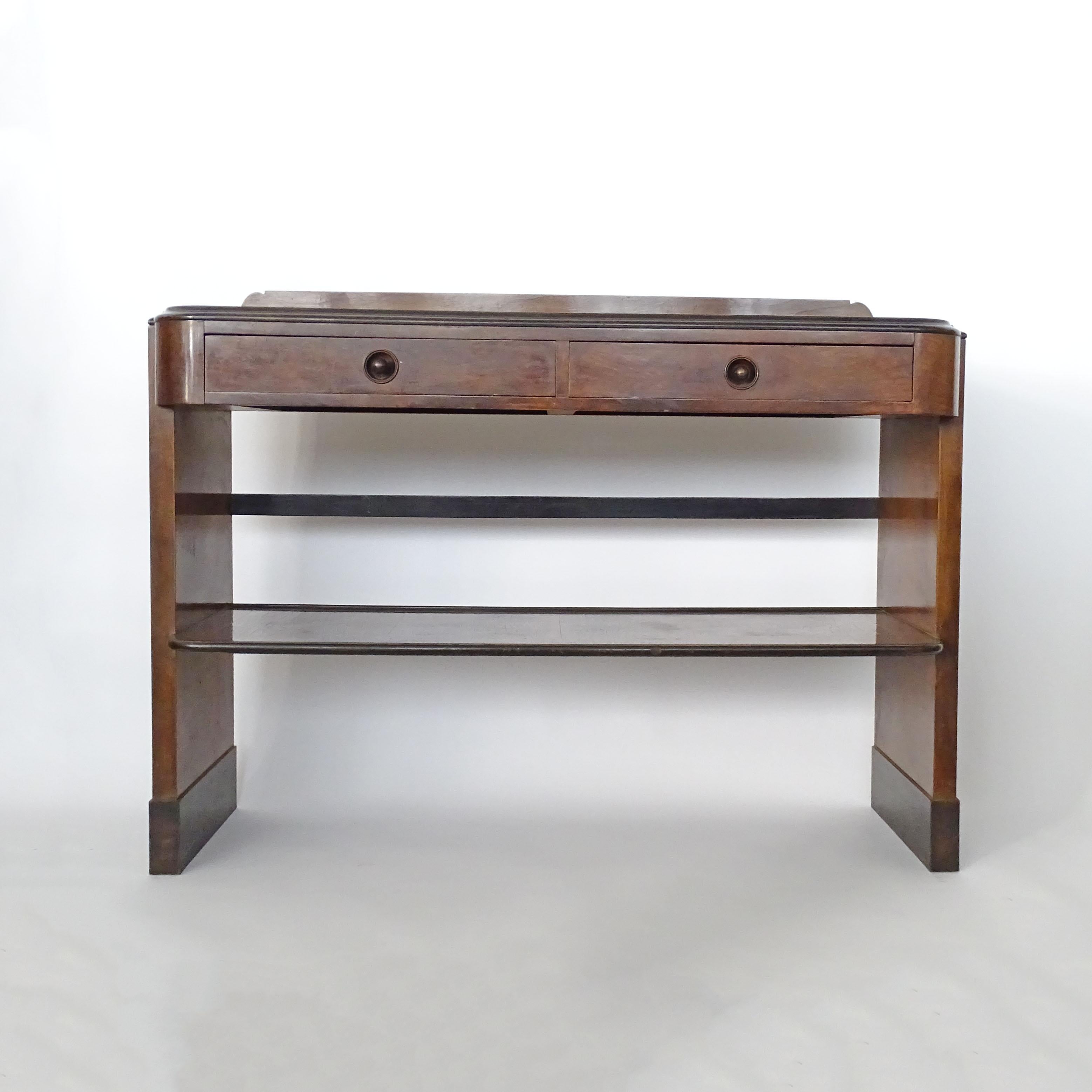 Italian Art Deco console with two drawers and a lower shelf. One drawer contains an original cutlery container in leather and wicker.
Attributed to Italian Master Architect Piero Portaluppi.