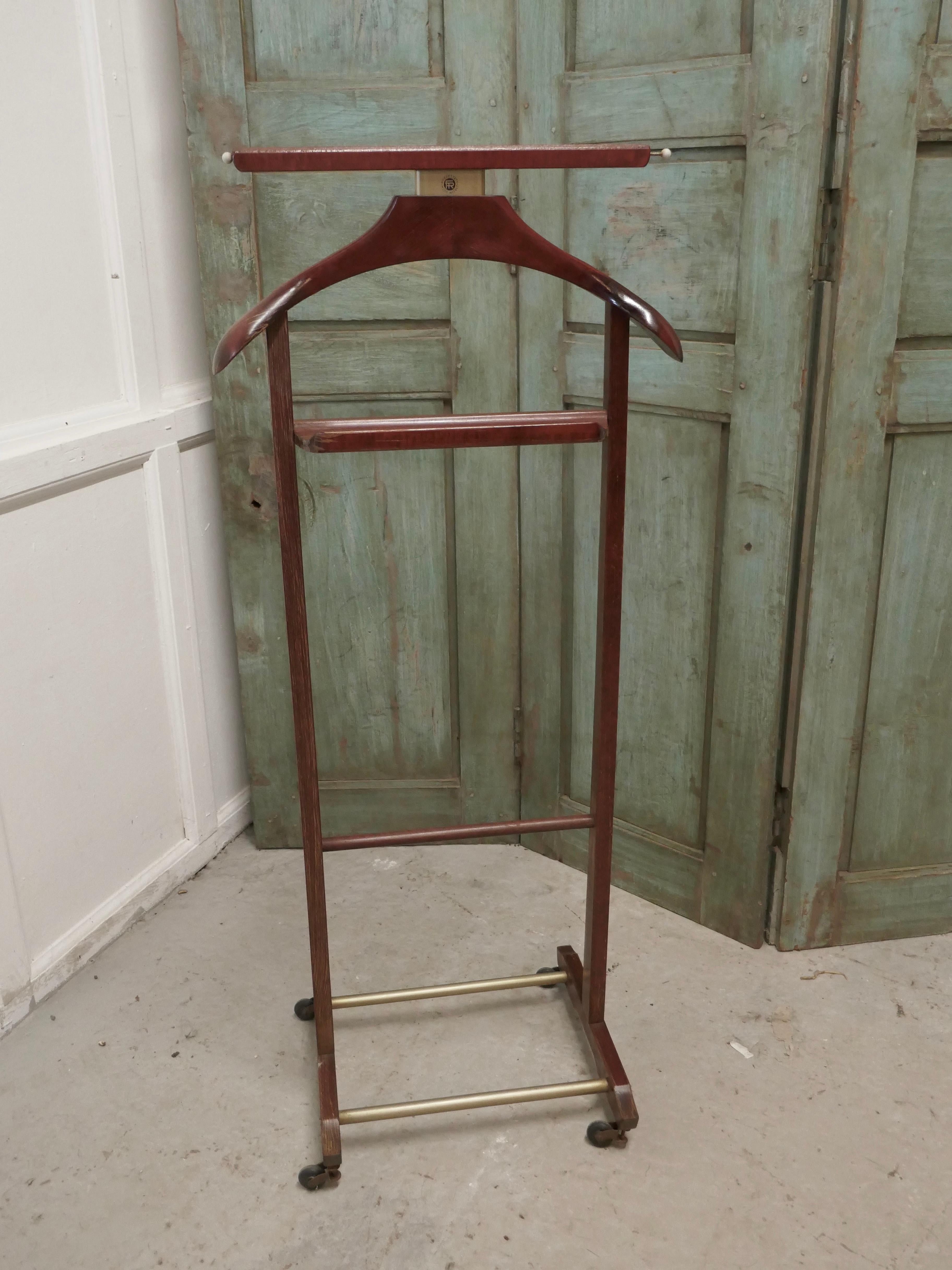 Italian Art Deco gentleman’s floor standing suit hanger by Brevettato

 A very useful piece, the hanger or clothes stand is made in Mahogany, it will accommodate jacket and trousers, but it would do just as well for your jeans and a jacket