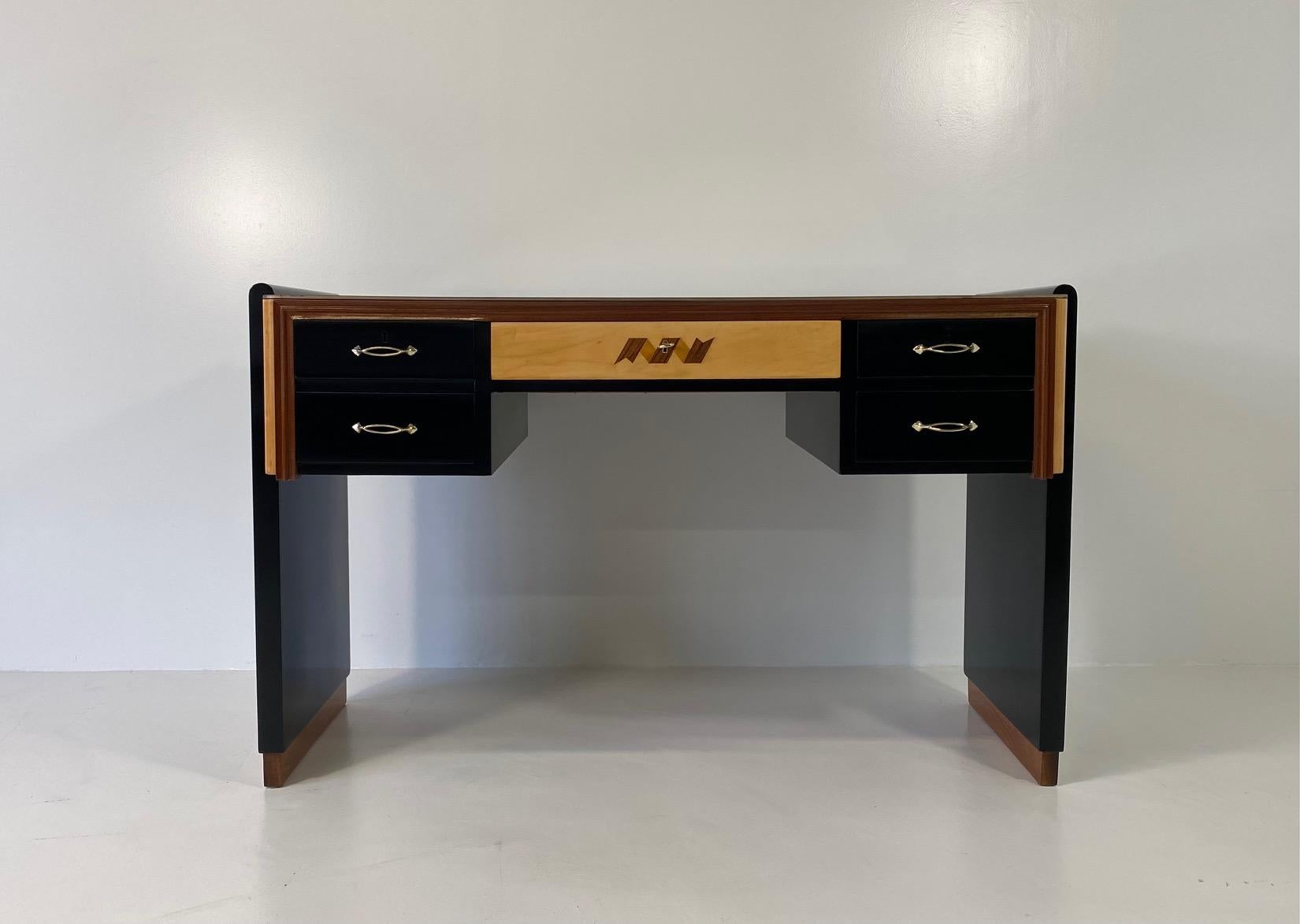 This valuable Art Deco desk was produced in the 1940s, in Cantù (village in the north of Italy) for the famous exposition 'Permanente mobili cantù' and is most likely based on a design by Paolo Buffa.
The desk has a black lacquered structure with