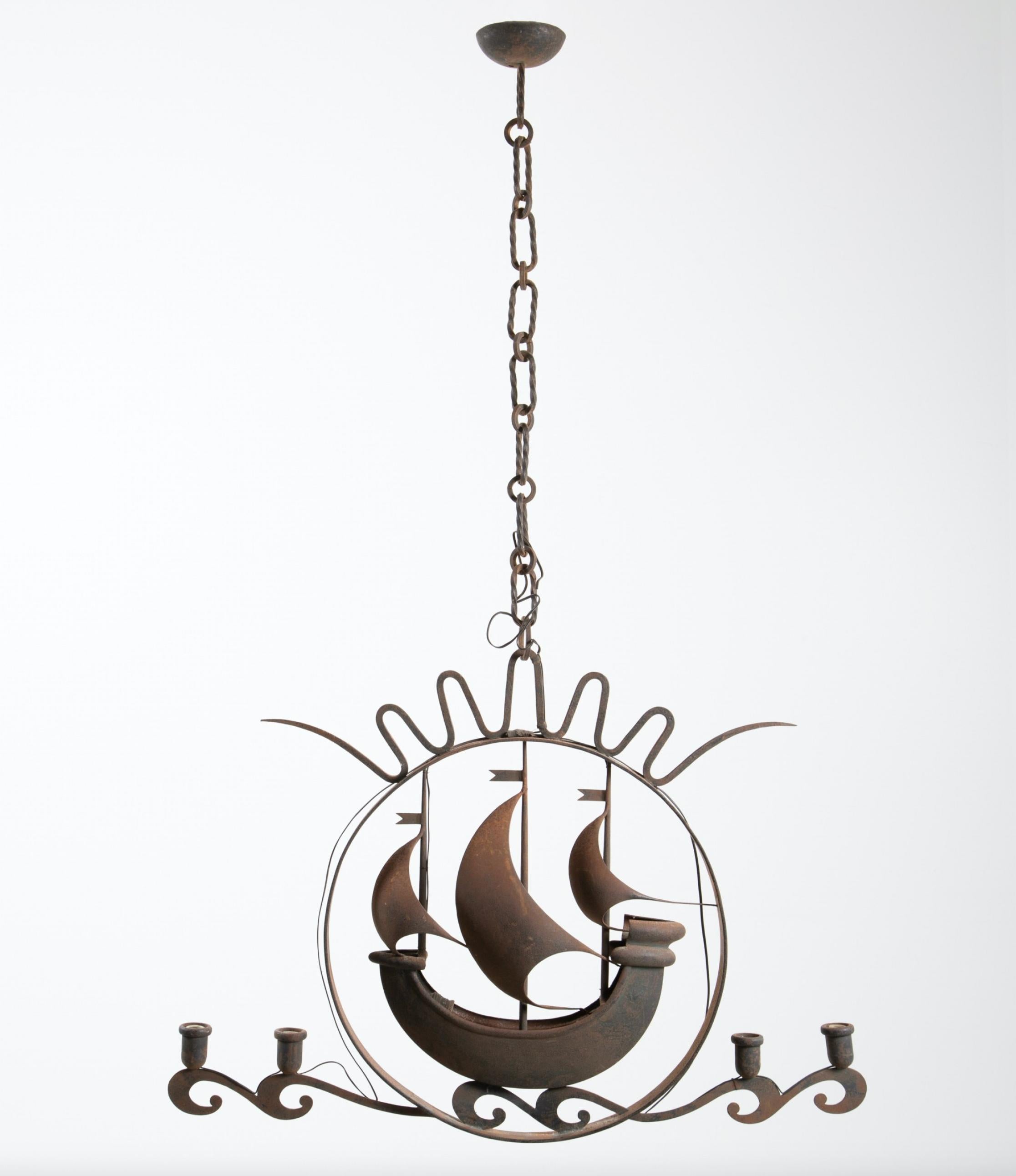 Attributed to Gio Ponti 1940s Italian iron hanging lamp in the form of a sailing ship vessel with three masts enclosed within a thin, circular framework resting on stylized waves, each with an attached light fixture; hanging chain atop.
Identical