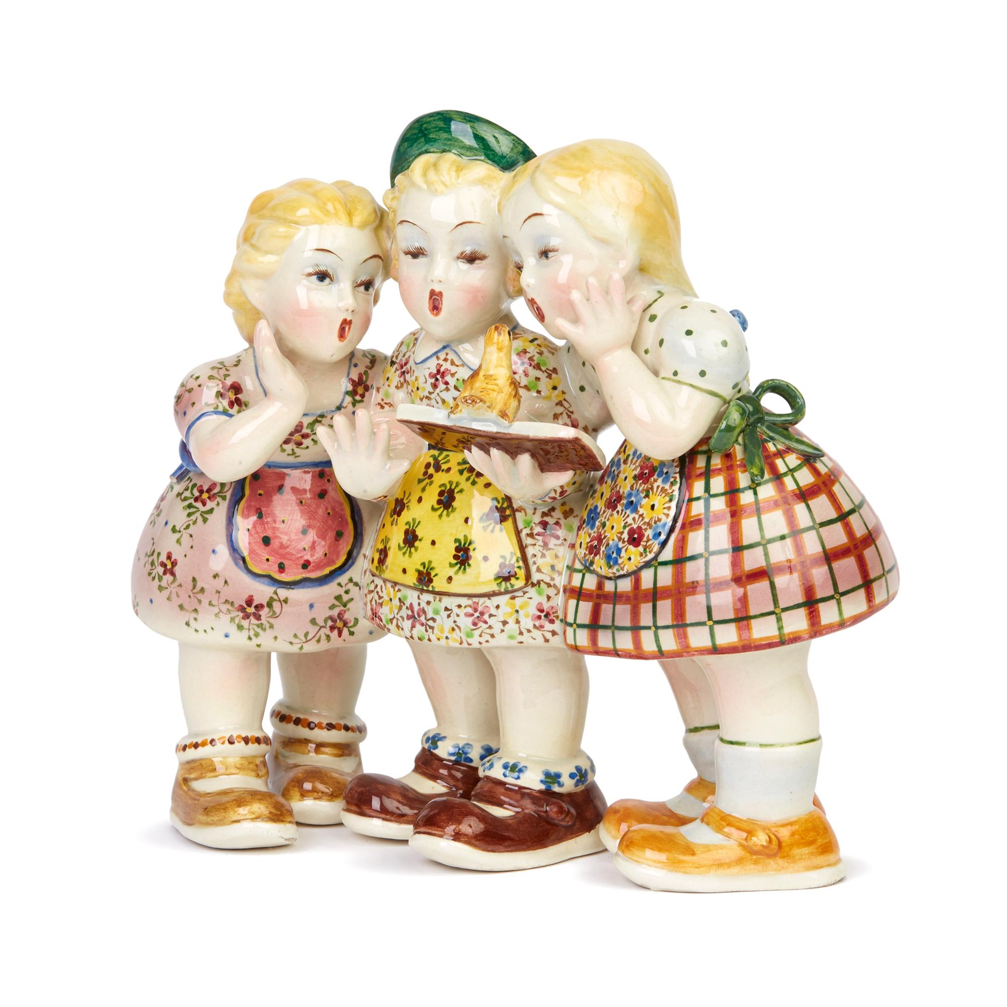 A charming and typically Italian art pottery figure group of three girls singing in the quality and style of Lenci dating between 1930-1950. The group portrays three young girls holding a musical score with a small bird perched on the edge with them