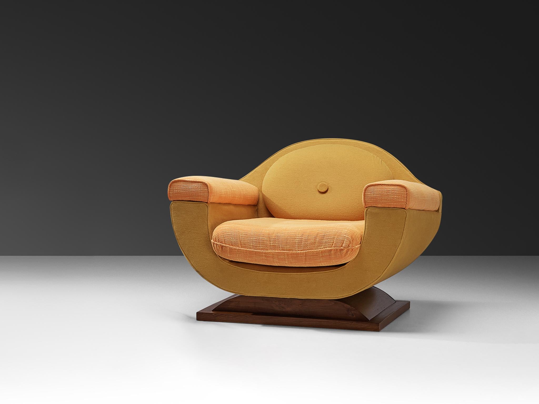 Lounge chair, fabric, stained walnut, Italy, 1940s

This exquisite lounge chair is a quintessential example of Italian Art Deco design, known for its sleek, streamlined curves and emphasis on geometric forms. With its charmingly bulky appearance,