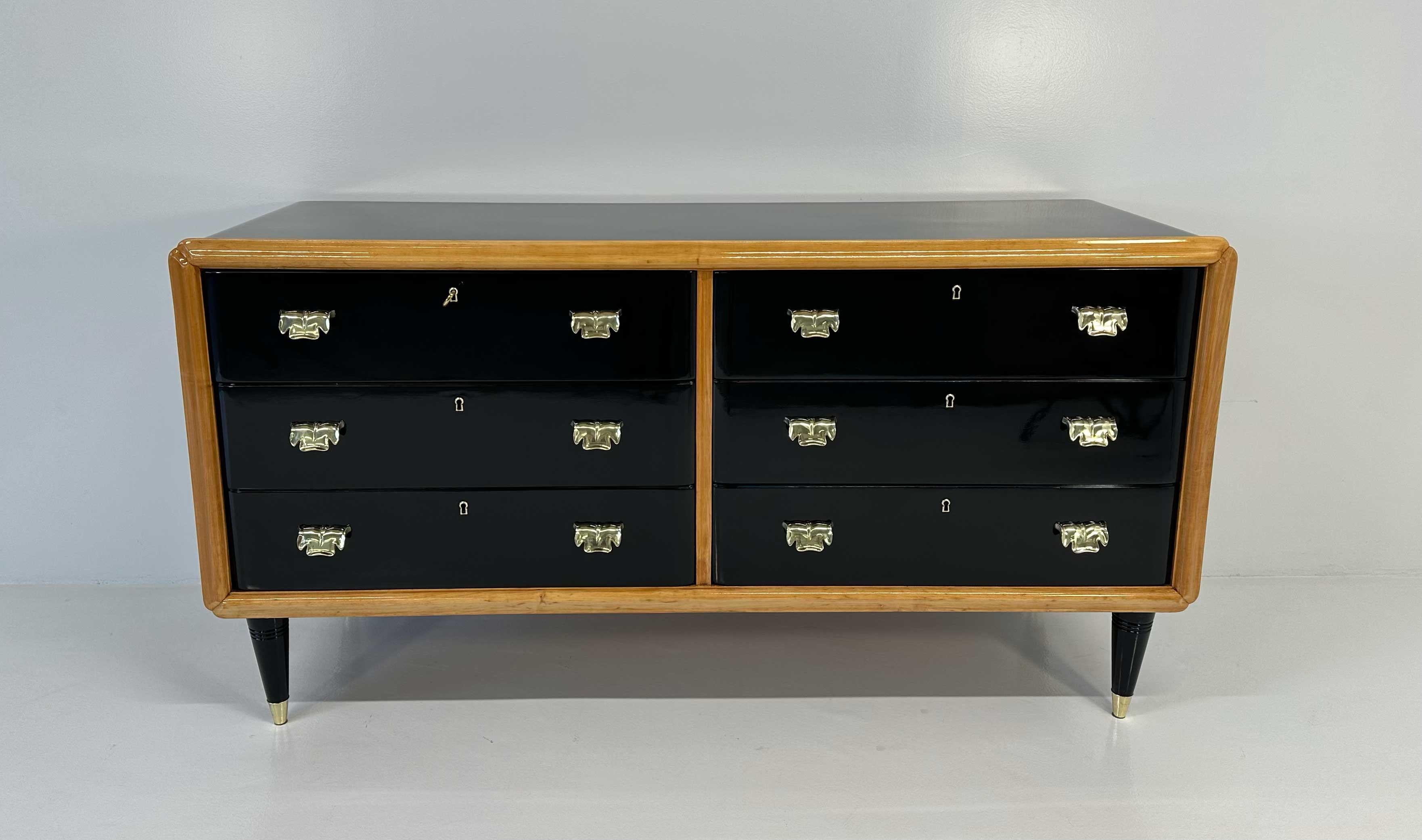 This Art Deco dresser was produced in Italy in the 1940s and it is attributable to the design of Paolo Buffa. It is completely black lacquered with maple profiles and brass handles and leg tips. 
Completely restored. 