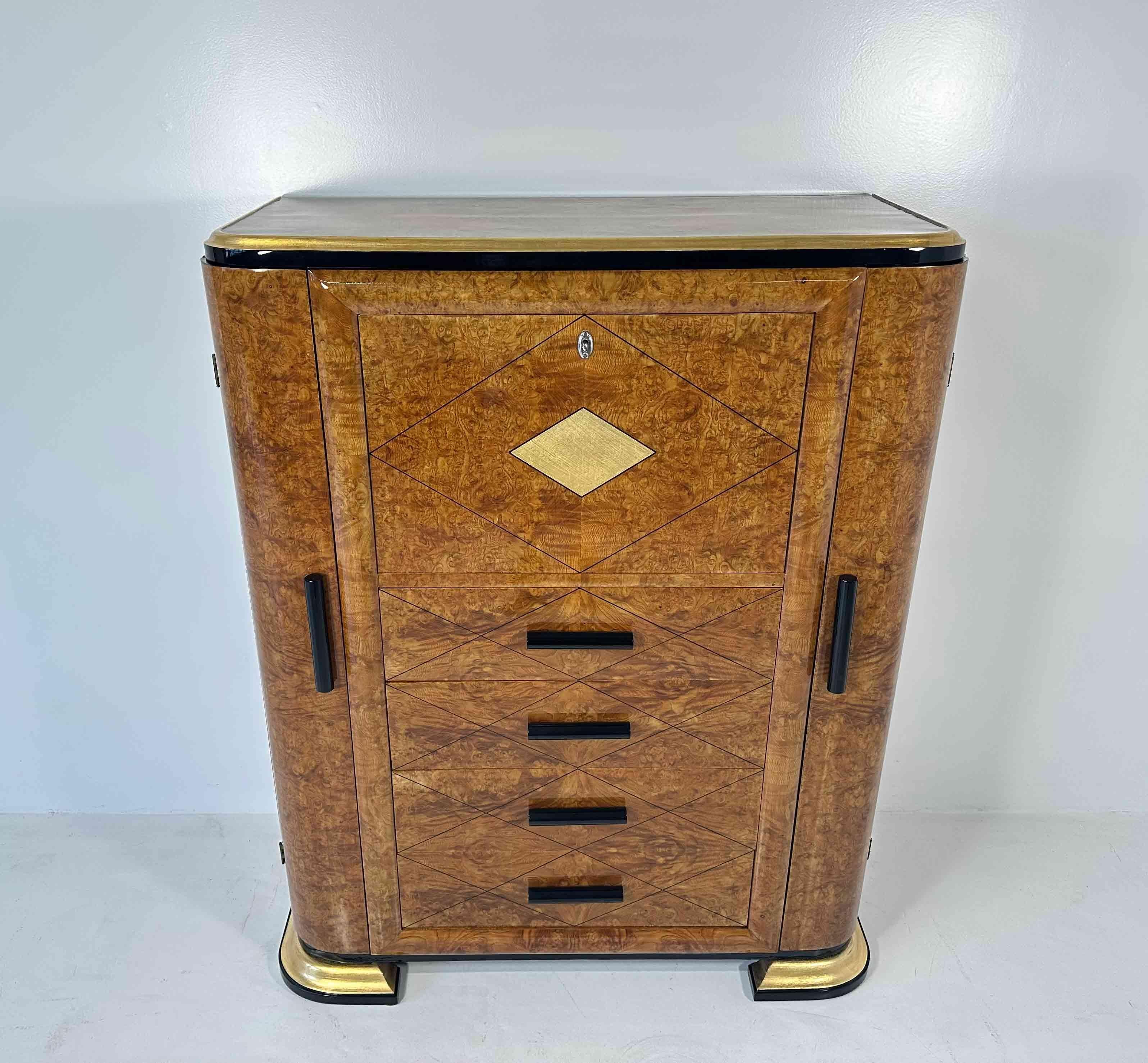 This Art Deco secrétaire was produced in Italy in the 1940s. 
It is completely made of an elegant maple briar, with black lacquered and gold leafed details. 
In particular, some of the profiles, the handles and the fine line rhomboidal decoration on