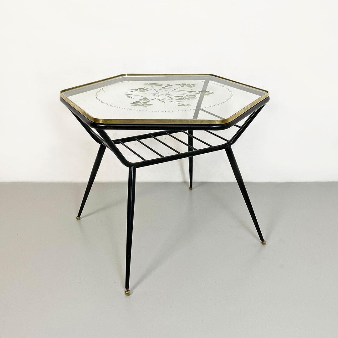 Italian art deco metal, decorated glass and brass coffee table with magazine rack, 1950s
Coffee table with metal rod magazine rack, hexagonal top edged in brass and decorative design on the transparent glass top. Ball tips in brass.
1950s
Good