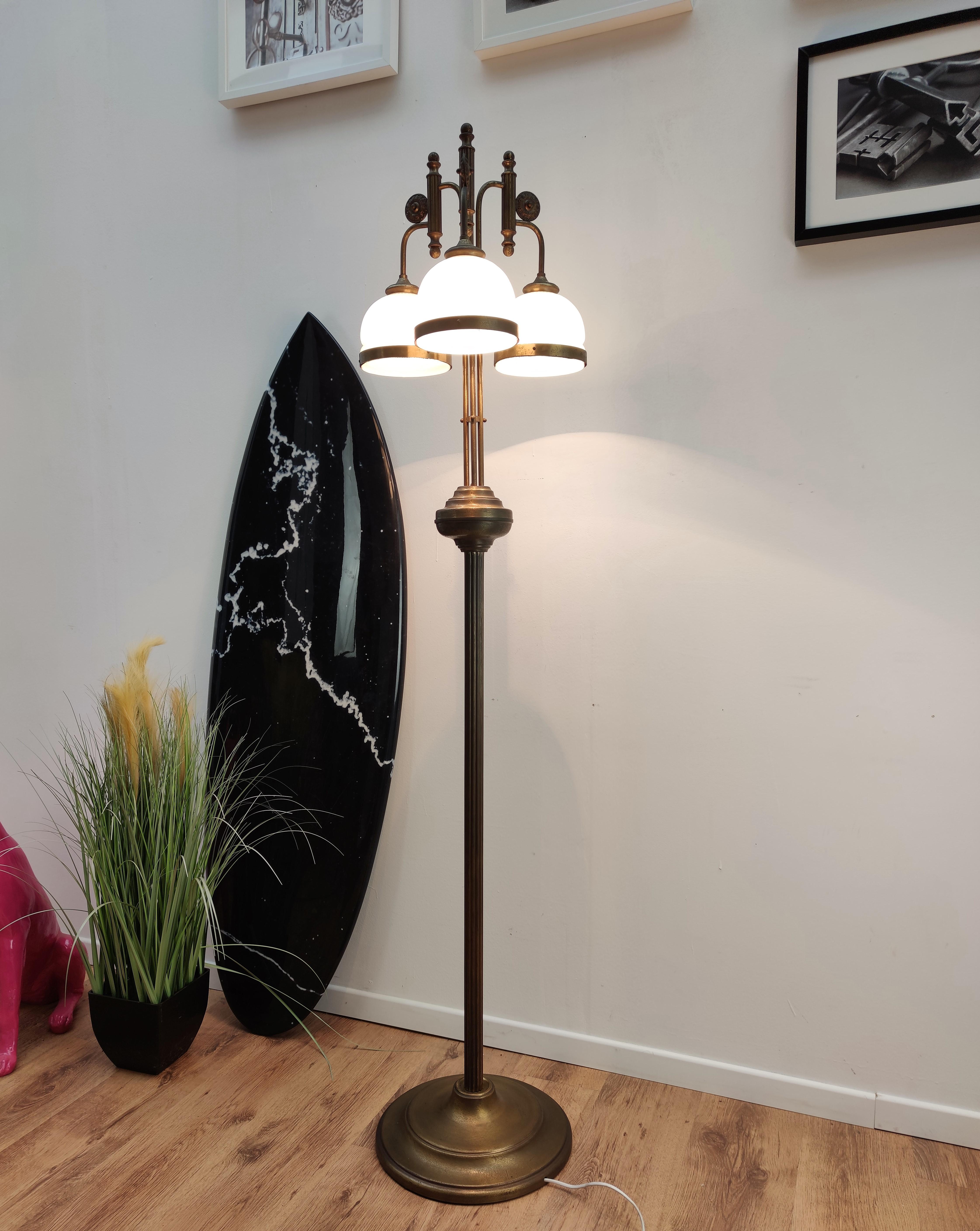 Beautiful Italian, in typical Art Deco style, three-armed waterfall floor lamp in brass with opaline milk glass lampshades. Art Deco lights are stylish, timeless, tasteful and Classic. In vogue for a short period of time, they remain a firm favorite