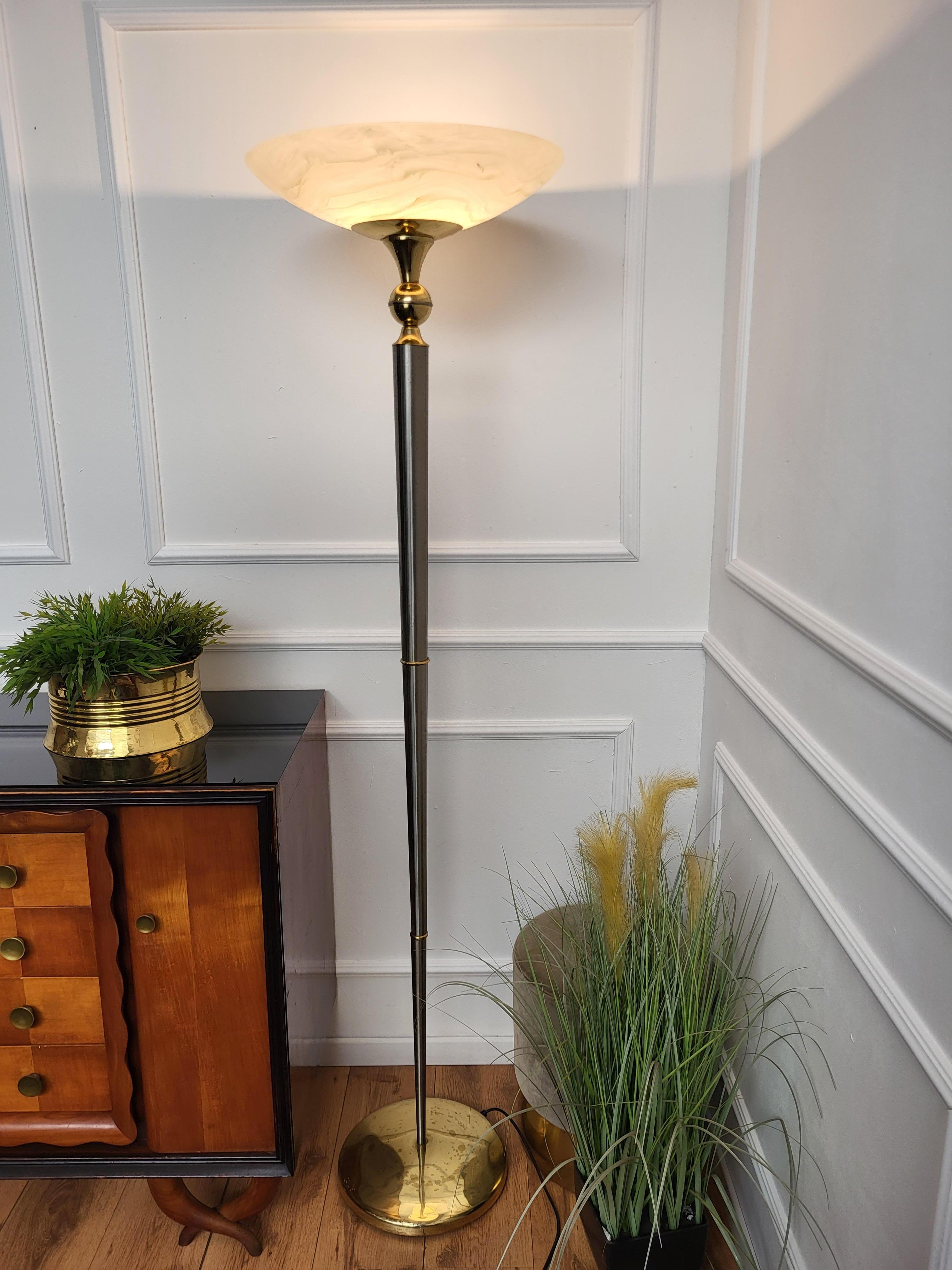 Beautiful Italian, in typical Art Deco and Hollywood Regency style floor lamp in silver brass and gilt brass with oval shaped glass lampshade. A stylish, timeless, tasteful and classic piece that perfectly adds to every home decor the typical glitz,