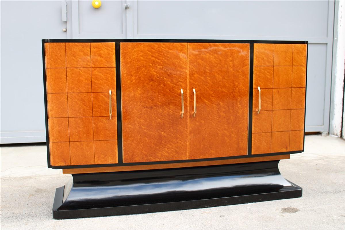 Italian Art Deco minimal sideboard in elm briar darkened walnut brass handles.
It has 4 doors of which the two sides contain the structures inside to hold the glasses and spirits to be served.
It presents a truly Minimalist and rational elegance,