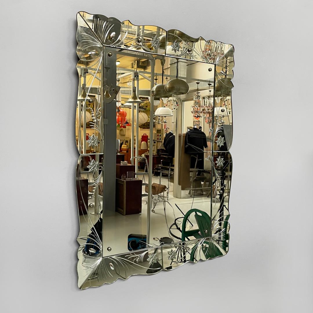 Italian Art Deco mirror by Luigi Brusotti for La Permanente Mobili, 1940s
Rectangular wall mirror with acid etchings in the shape of stars and leaves. Wooden structure with mirrored glass frame.
On the wavy profile, composed of eight joined parts,
