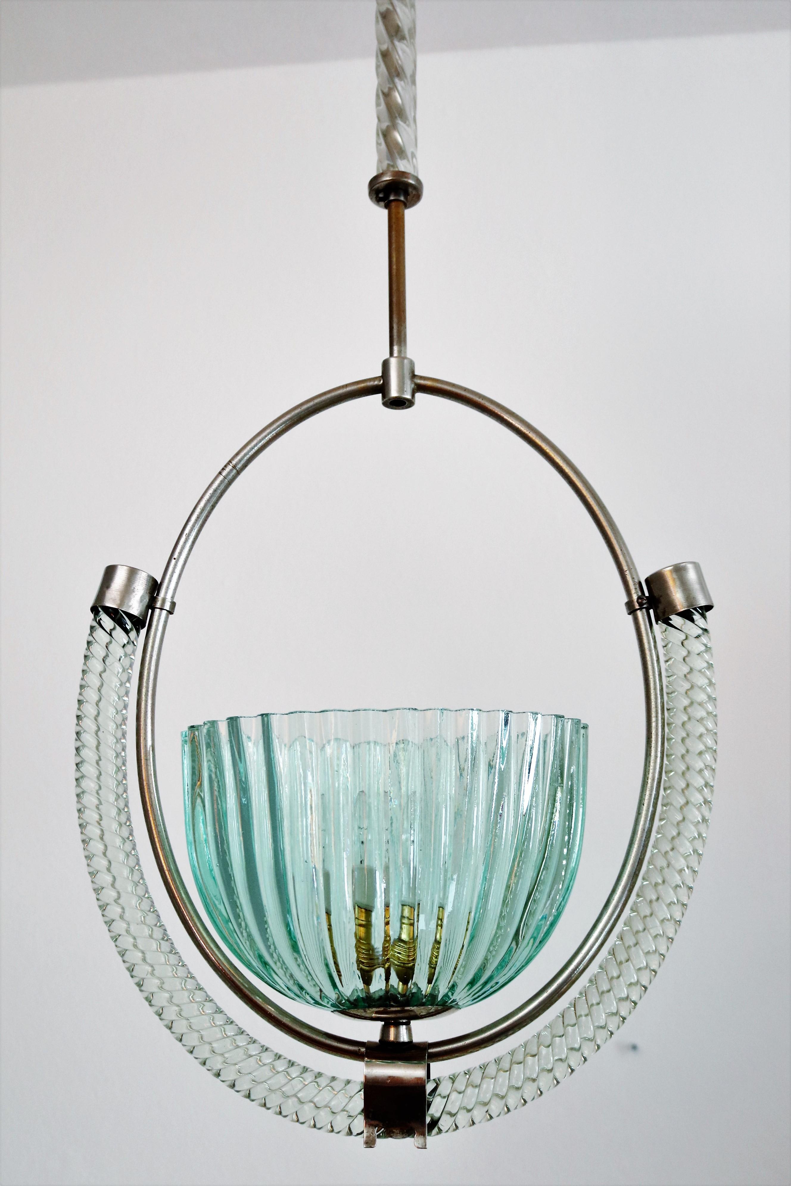 Gorgeous and rare Italian pendant made of light green and transparent colored Murano glass.
The glass parts are handmade and are of highest craftsmanship.
The lamp's frame is made entirely of chromed brass parts.
The pendant light have been newly