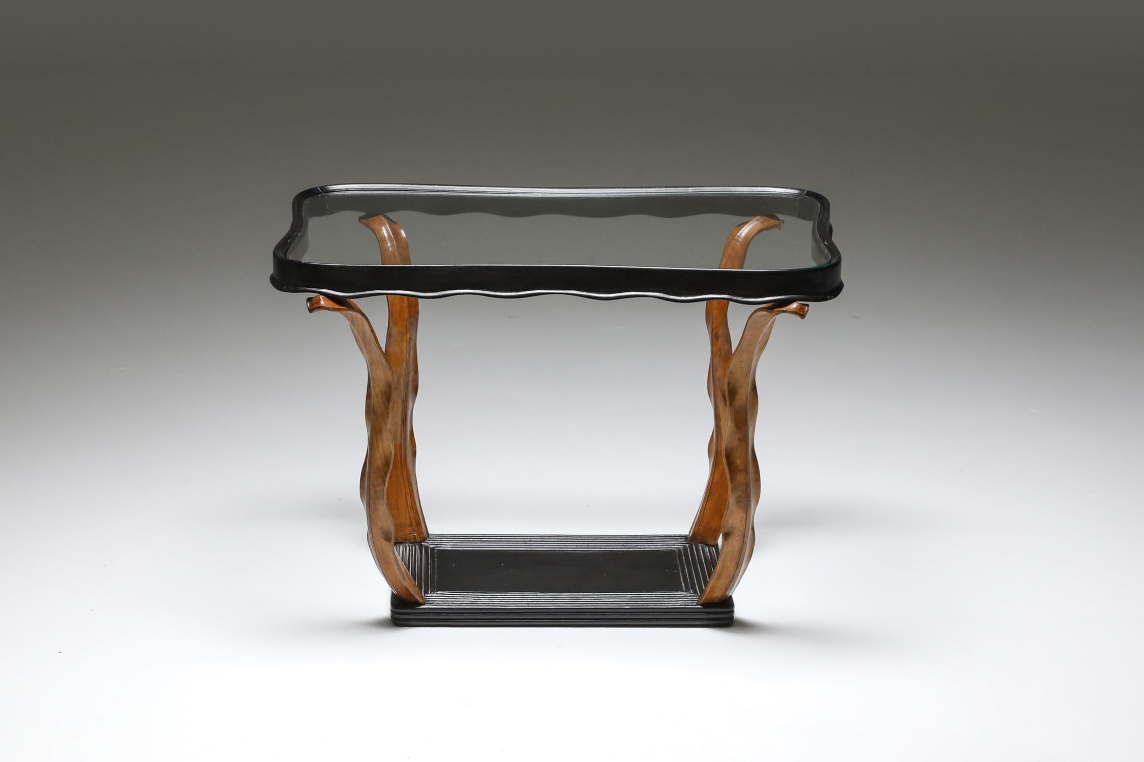Paolo Buffa, table, glass top, Italy 1940s

Beautiful occasional table with ebonized bottom and top tray, connected by a foliage like hand-carved walnut feet.
 
