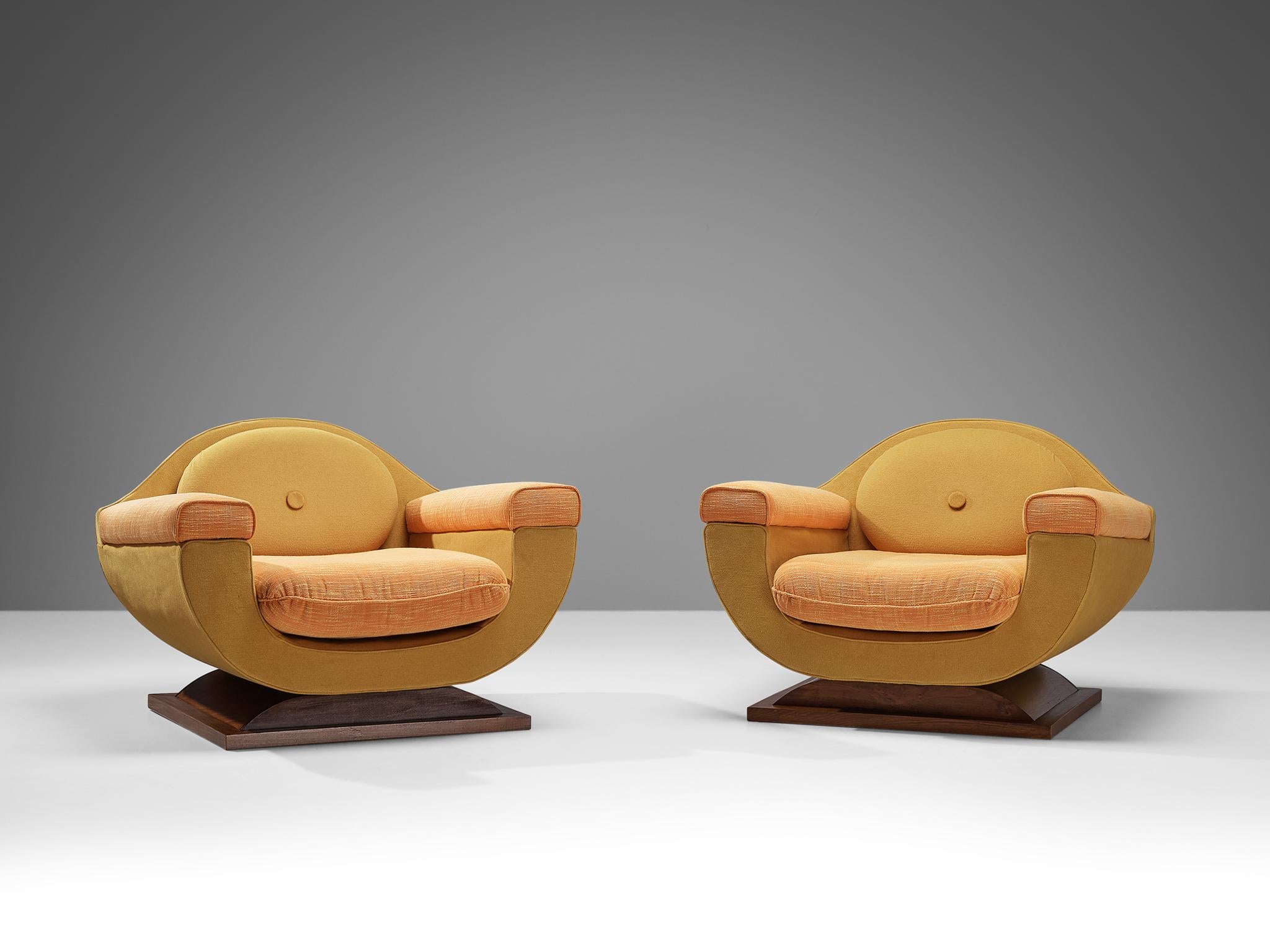 Pair of lounge chairs, fabric, stained walnut, Italy, 1940s

These exquisite lounge chairs are quintessential examples of Italian Art Deco design, known for its sleek, streamlined curves and emphasis on geometric forms. With their charmingly bulky