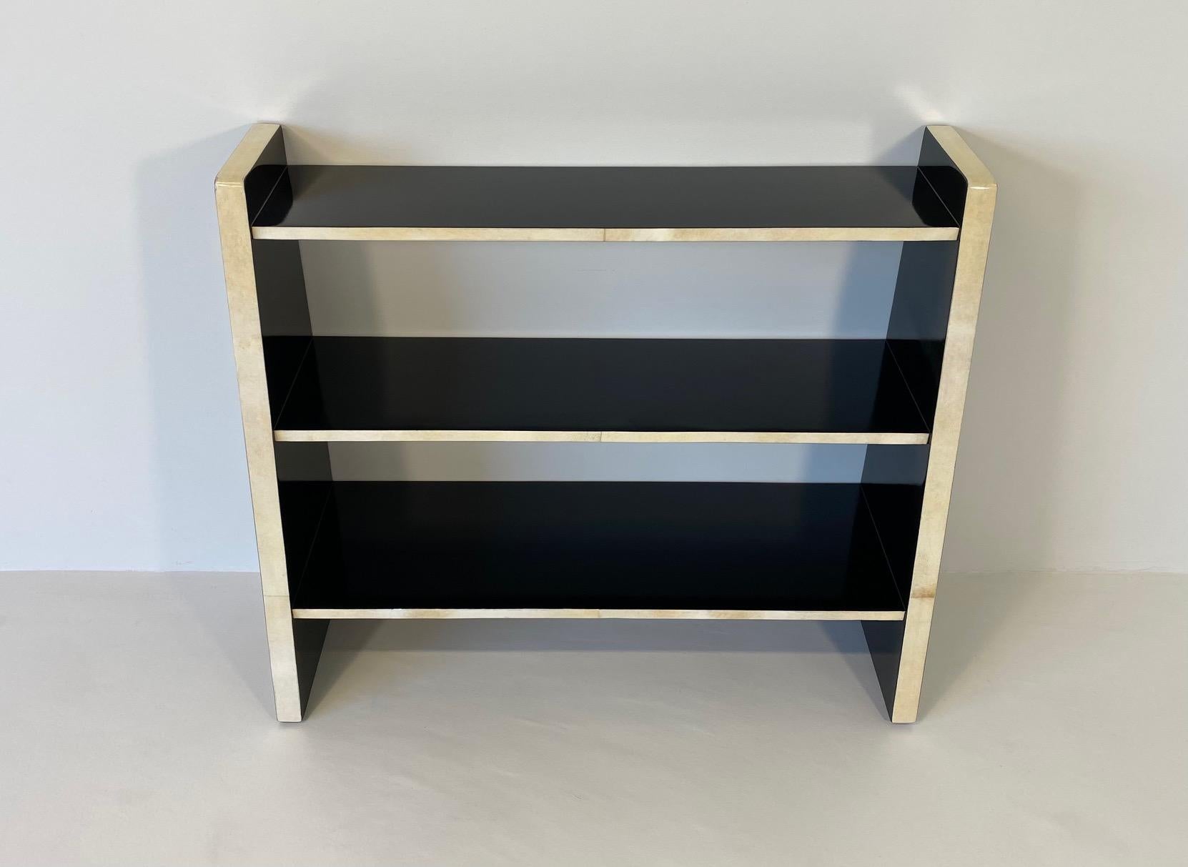 This Art Deco bookcase was produced in Italy in the 1980s. 

The structure is completely black lacquered, while the frontal edges are in parchment. 
It has been completely and finely restored in our laboratories.