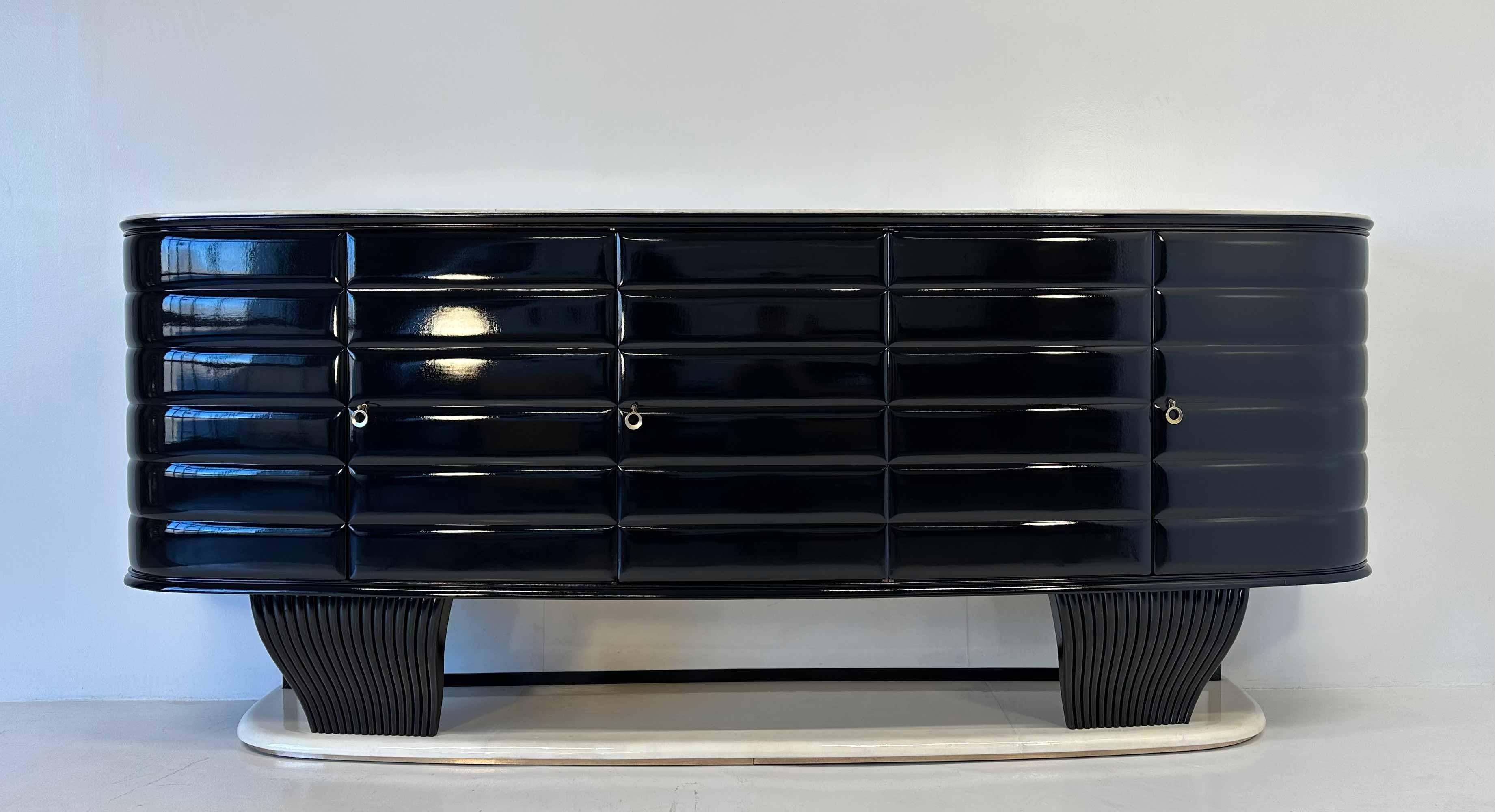 This unique Art Deco sideboard was produced in Italy in the end of the 1940s by Vittorio Dassi.

The laterals, the middle part and the legs are black lacquered, while the top and the base are in parchment, with a brass edge on the base and brass