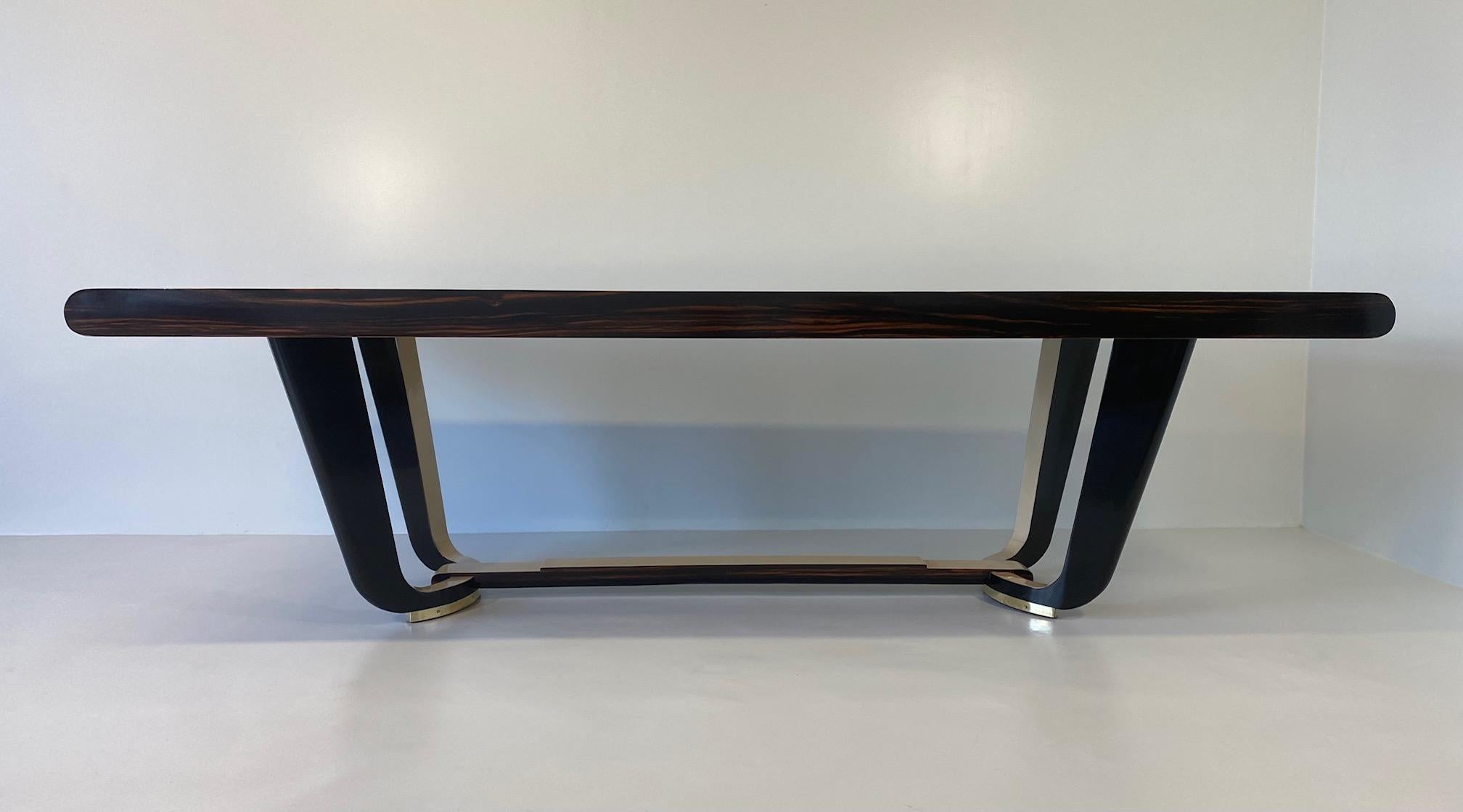 This elegant Art Deco table was produced in Italy in the 1940s.

The top, the upper part of the base and the internal part of the legs are in parchment. The edges of the top and the central base are in a precious exotic wood, while the external