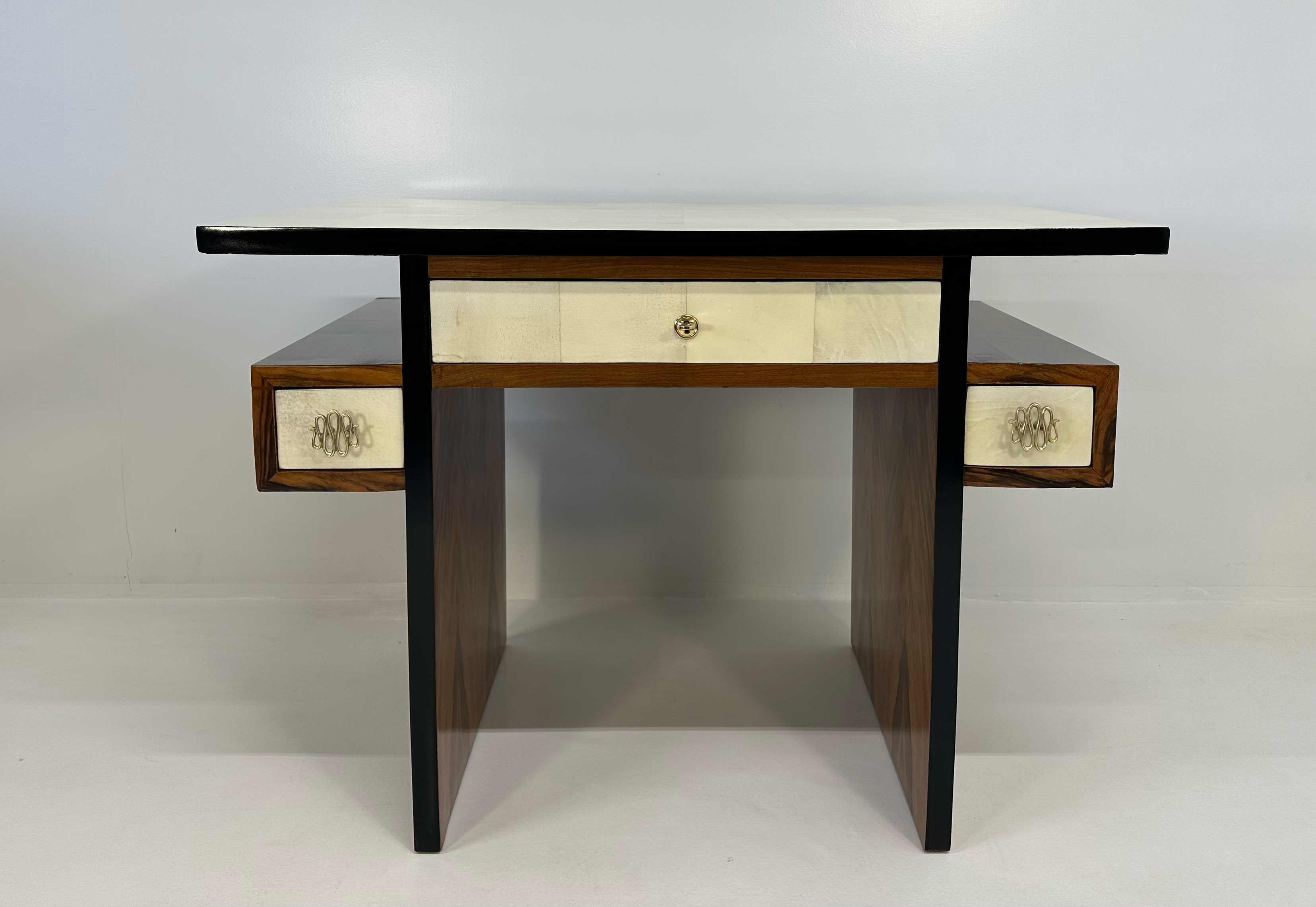 This elegant Art Deco desk was produced in Italy in the 1940s. 
The top and the drawers are in fine parchment in shapes of squares. The frontal part, the back and the sides are in Walnut Root, while the handles and other small details are in brass.