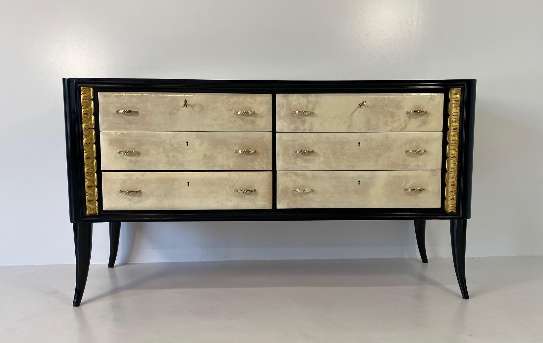 This Art Deco dresser was produced in Italy in the 1940s.

This dresser features six parchment drawers with a black lacquered structure and two gold leaf decorations. 

The handless are in brass.

Matching nightstands available. 