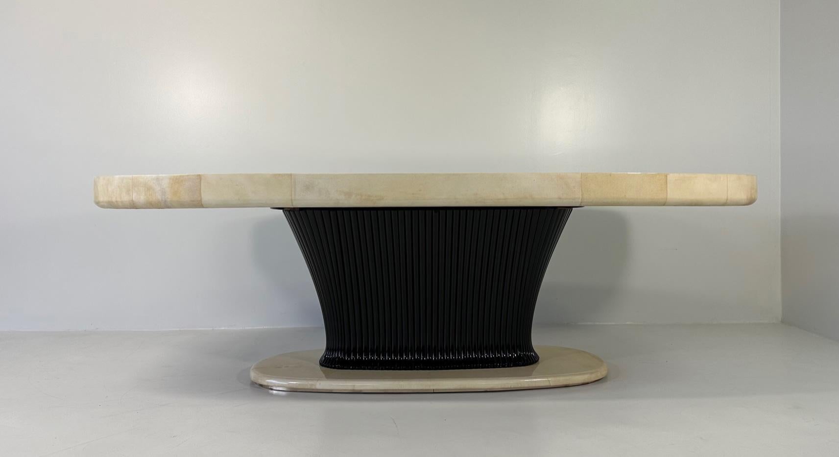This Art Deco table was produced in Italy in the 1940s by Vittorio Dassi. 
The top and the base are in parchment, while the central column is in ribbed black lacquered solid wood. The lower part of the base is enriched by a brass profile.