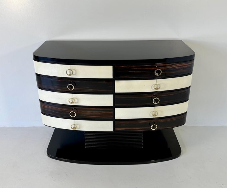This Art Deco Chest of Drawers was produced in Italy in the 1950s. 

The structure is black lacquered, while the drawers are bicolor due to the fact that they are in parchment and Macassar. 

Completely restored.