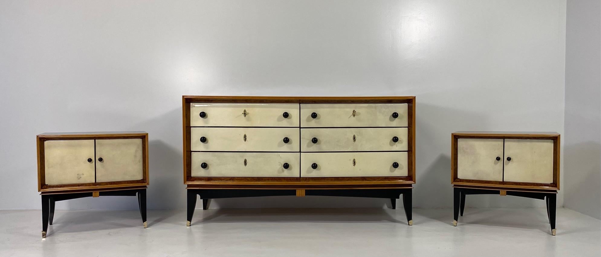 This dresser was produced in Italy in the 1940s. 
The six drawers are covered in parchment and are framed by a briar walnut profile, which is also framed by a profile in maple. 
Also the profile and the decorations on the black lacquered base are in